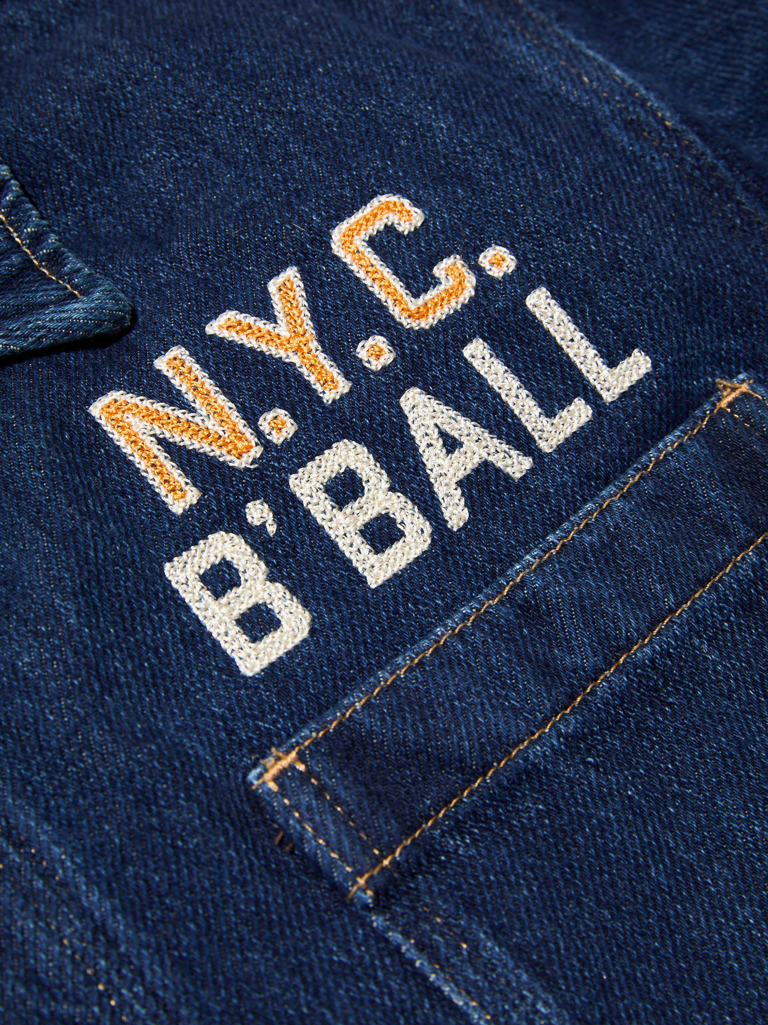 Embroidered 'N.Y.C. B'Ball' on a blue denim jacket