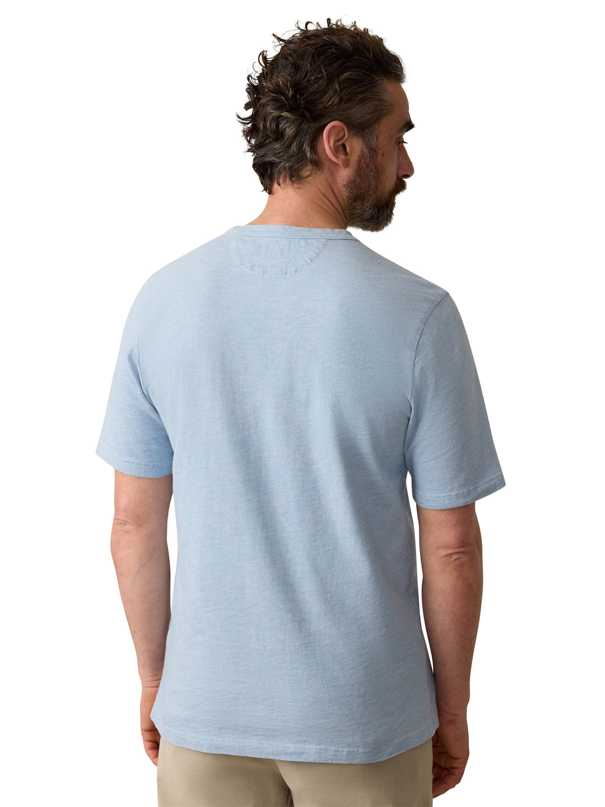 A man viewed from behind wearing a blue tee and beige pants, image 3 of 3