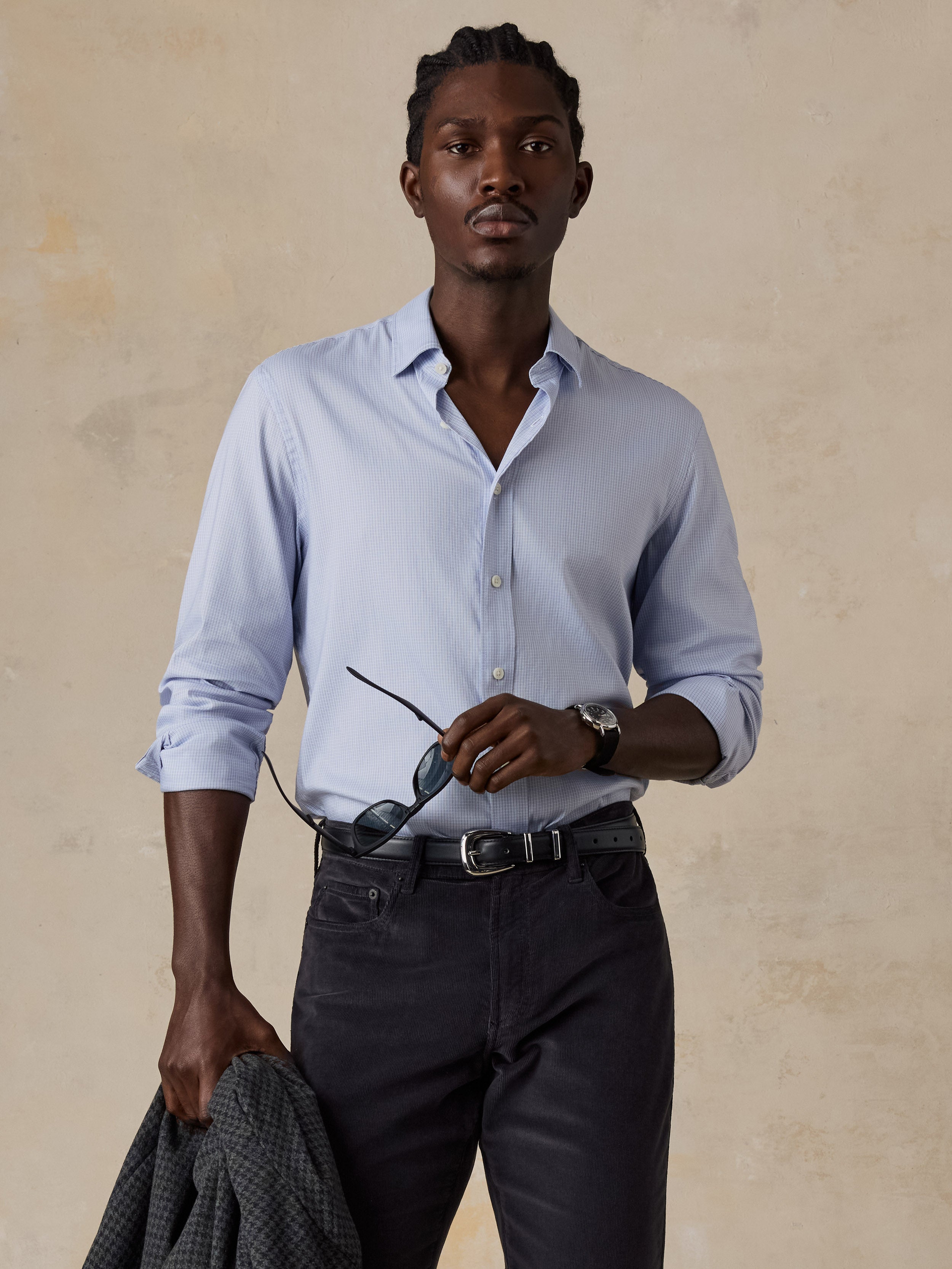 A man wearing a blue shirt and dark pants