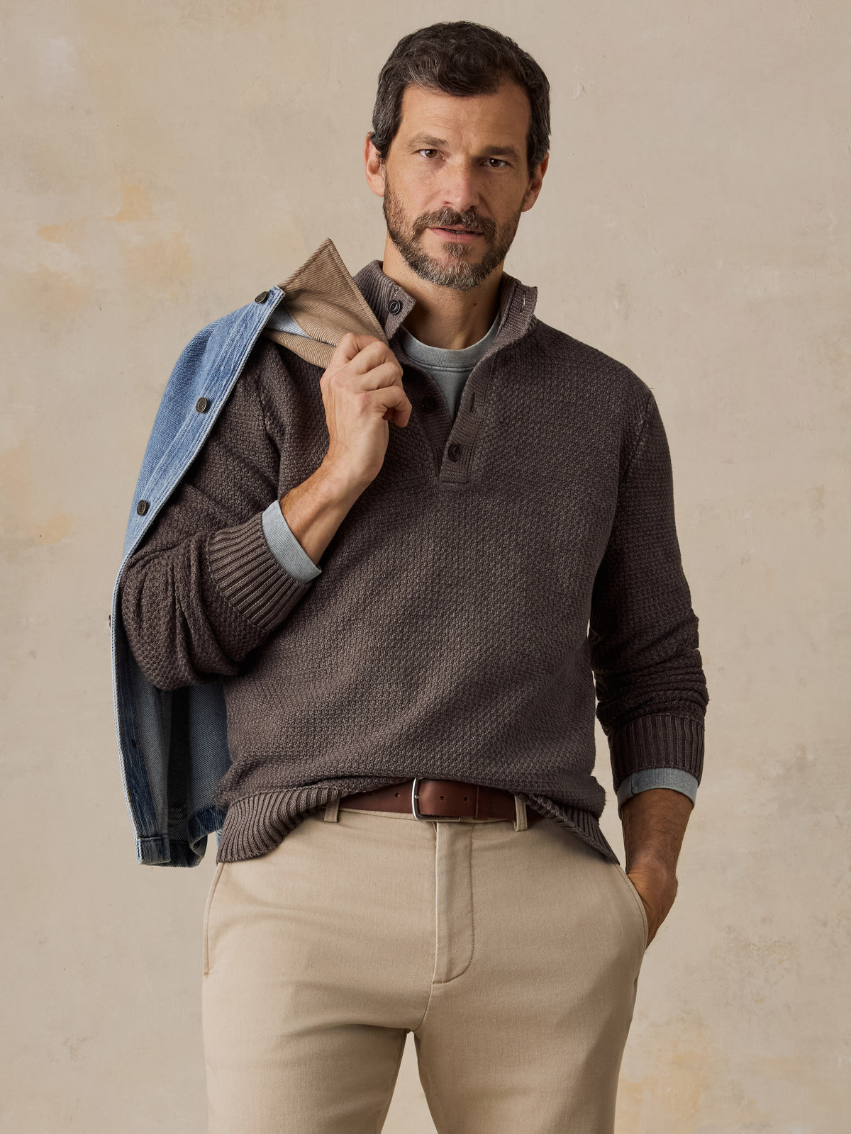 Man wearing a brown sweater and chino pants , image 1 of 5