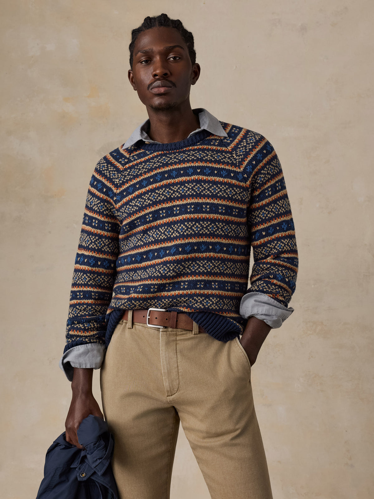 Man wearing a nordic printed sweater and beige pants , image 2 of 6