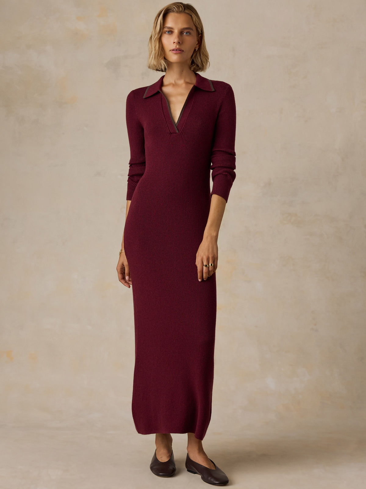A woman wearing a burgundy red dress and flats, image 2 of 7