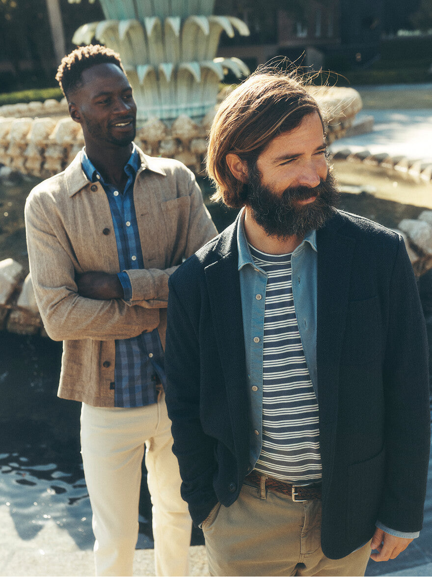Two men in Faherty Reserve collection standing in front of a fountain