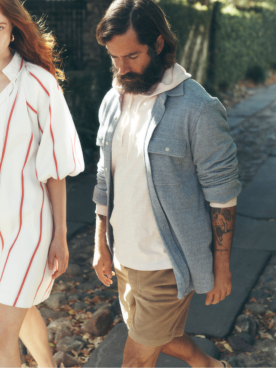 A man and a woman walking down the street wearing Faherty SP26 collection