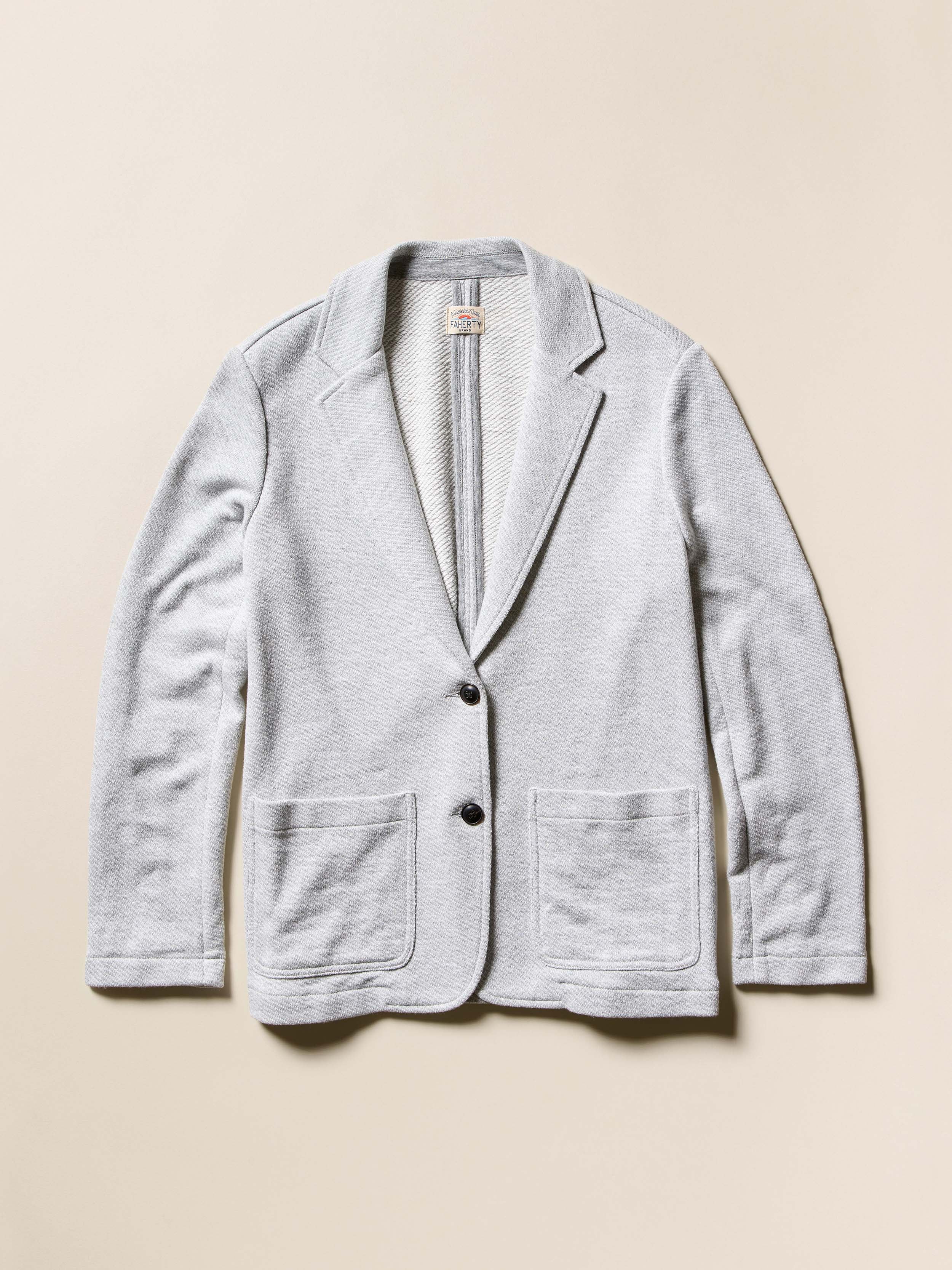 A grey blazer against a beige background