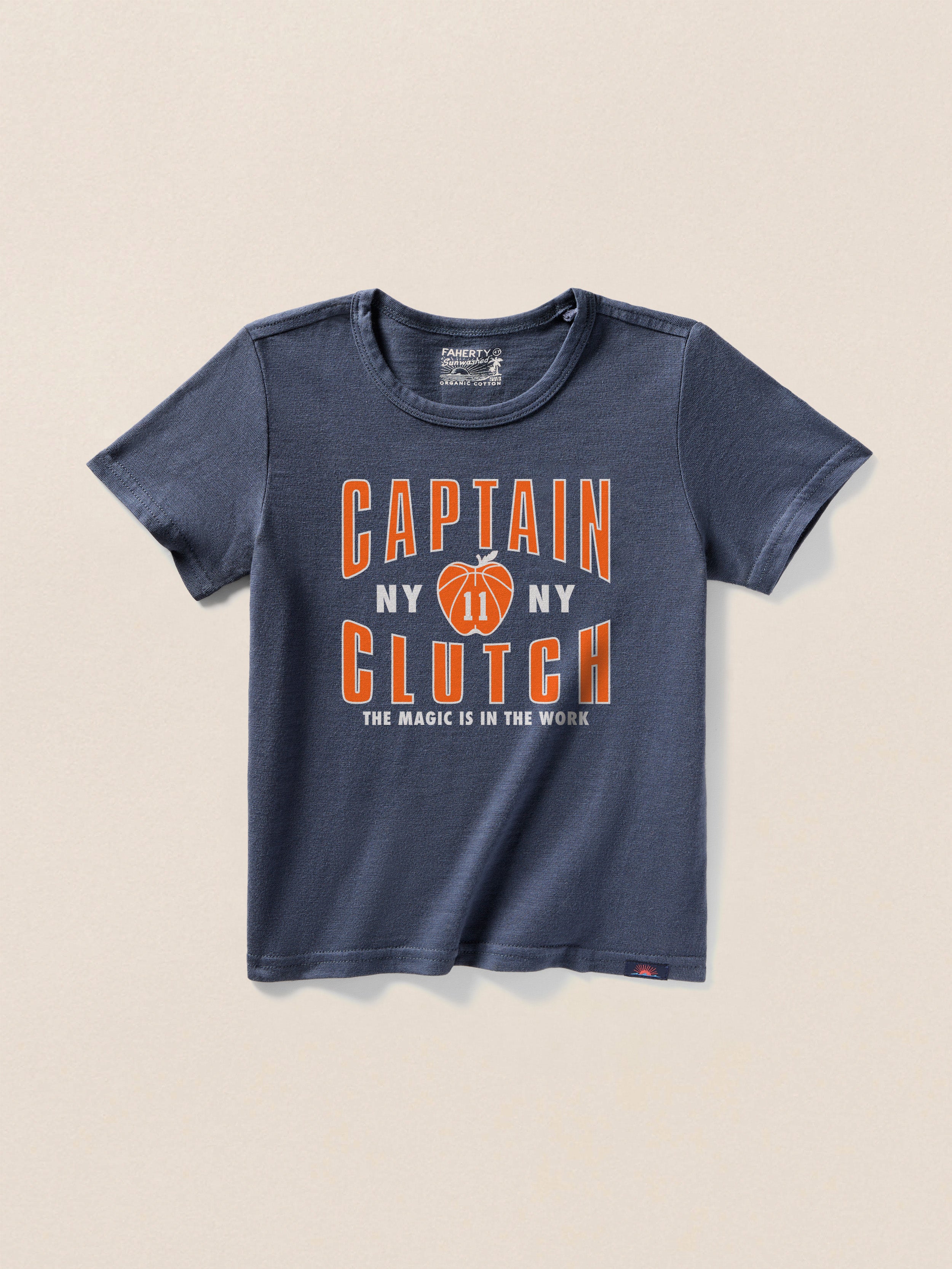 Navy blue t-shirt with a "Captain Clutch" graphic on the center front against a beige background