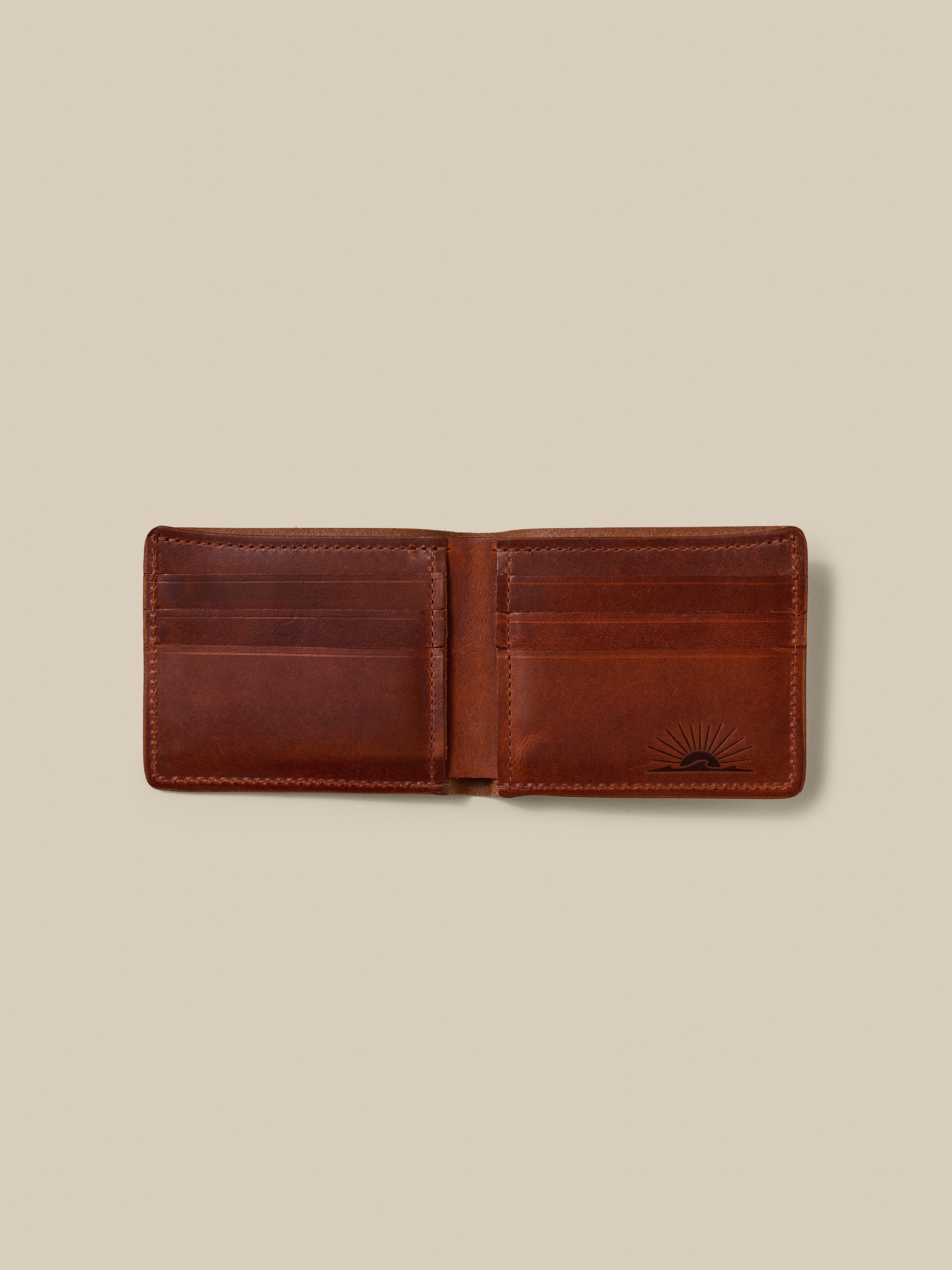 Brown leather wallet against a beige background