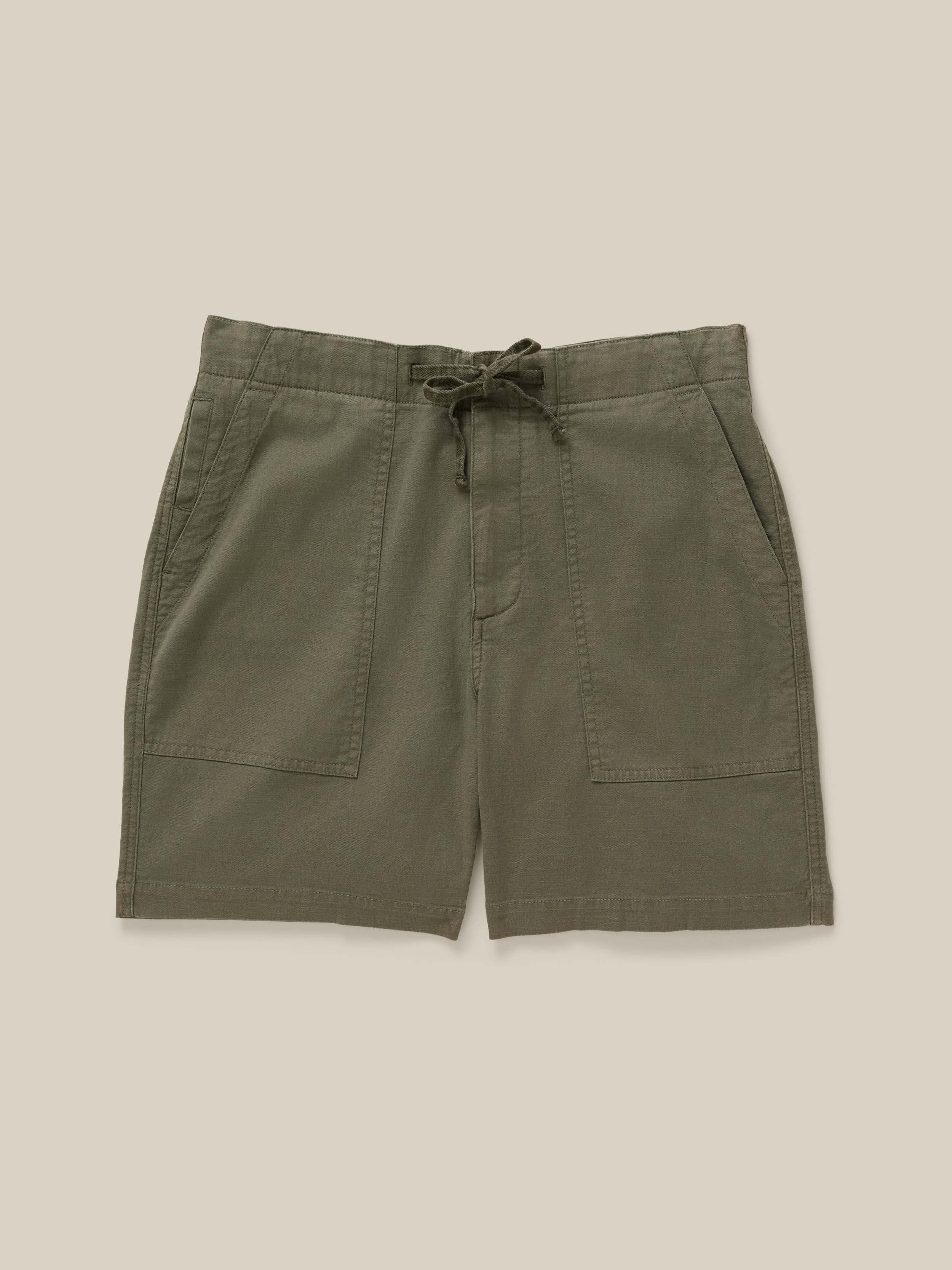 Green shorts with a drawstring on a beige background