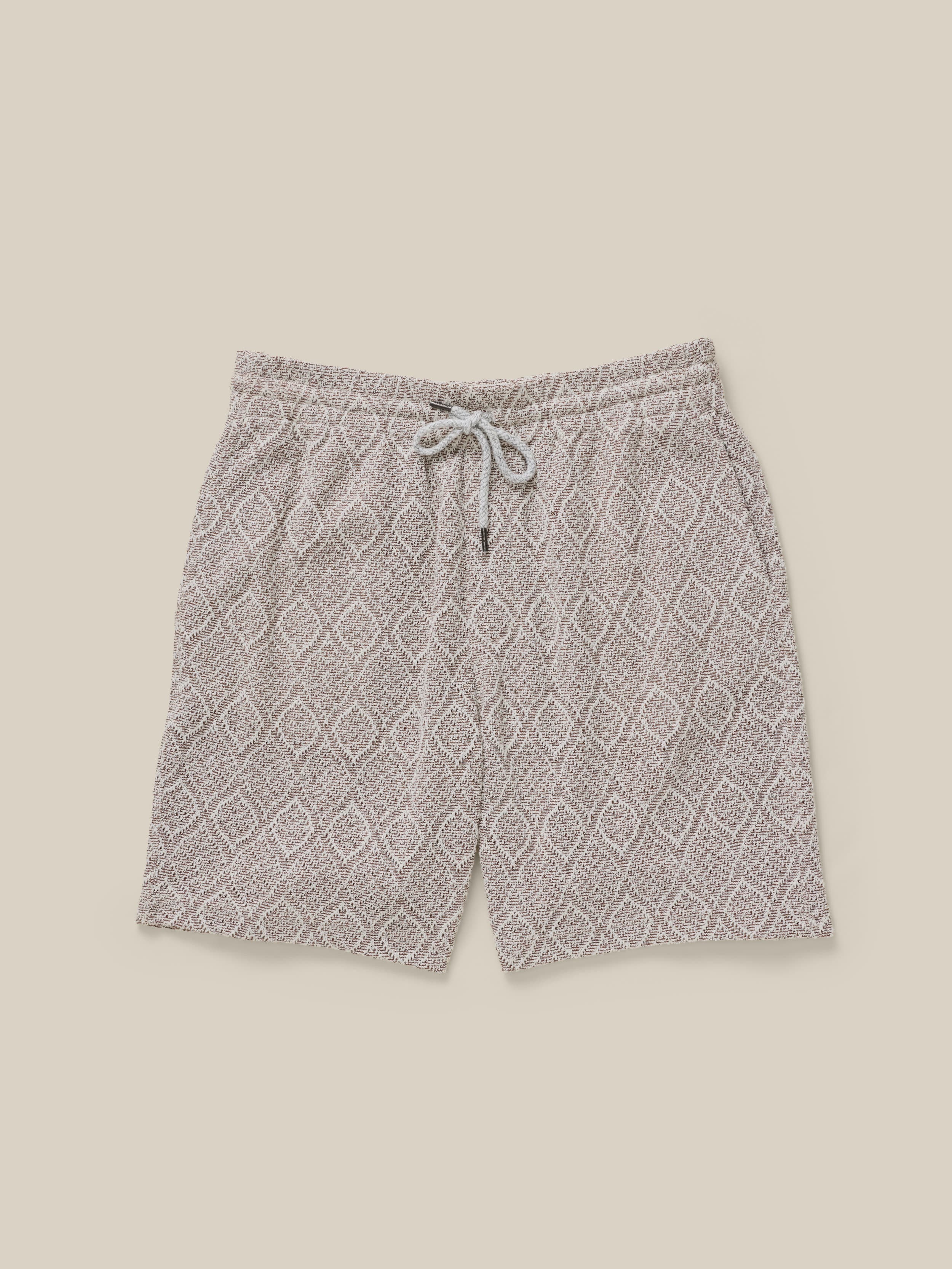 Gray patterned shorts on a beige background