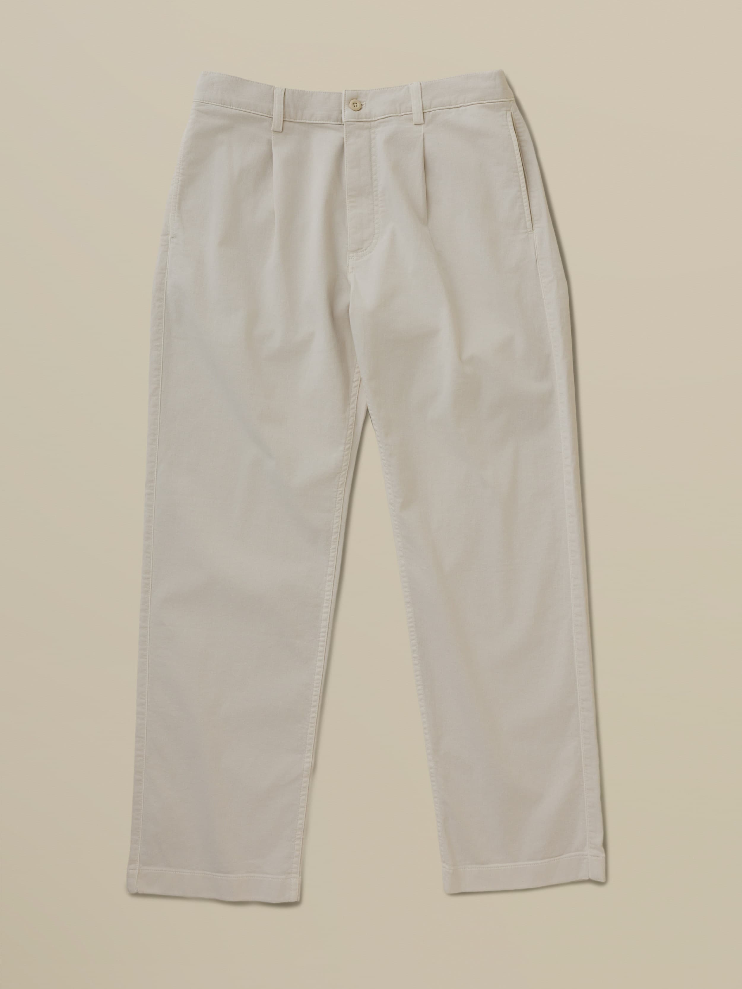 Beige khaki pants against a beige background