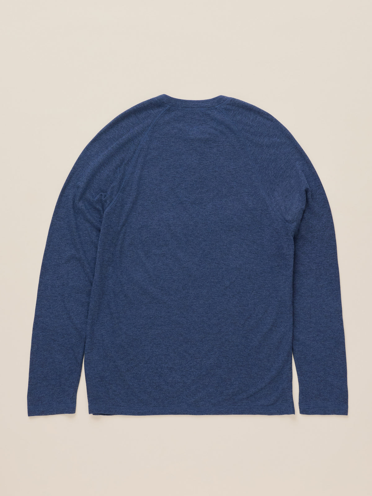 A heathered blue long-sleeve shirt shown from the back, laid flat against a light beige background., image 2 of 2