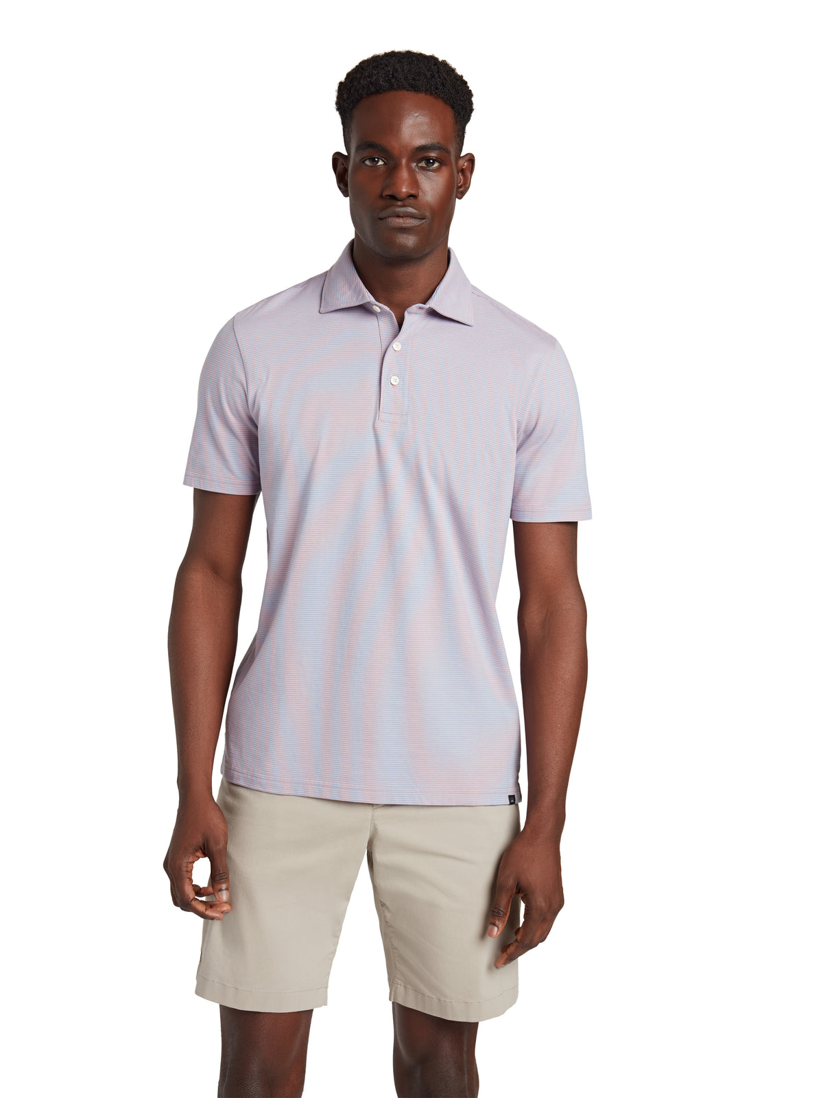 A man wearing a lavender polo and beige shorts, image 1 of 3