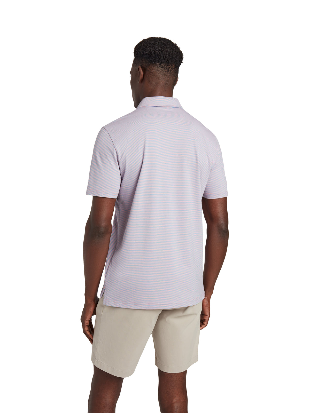 A man viewed from behind wearing a lavender polo and beige shorts, image 3 of 3