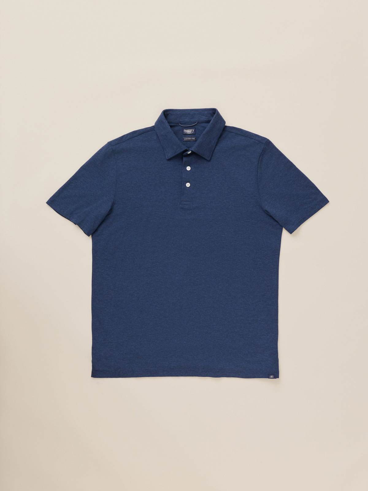 A blue short-sleeve polo shirt against a warm beige studio background, image 7 of 8