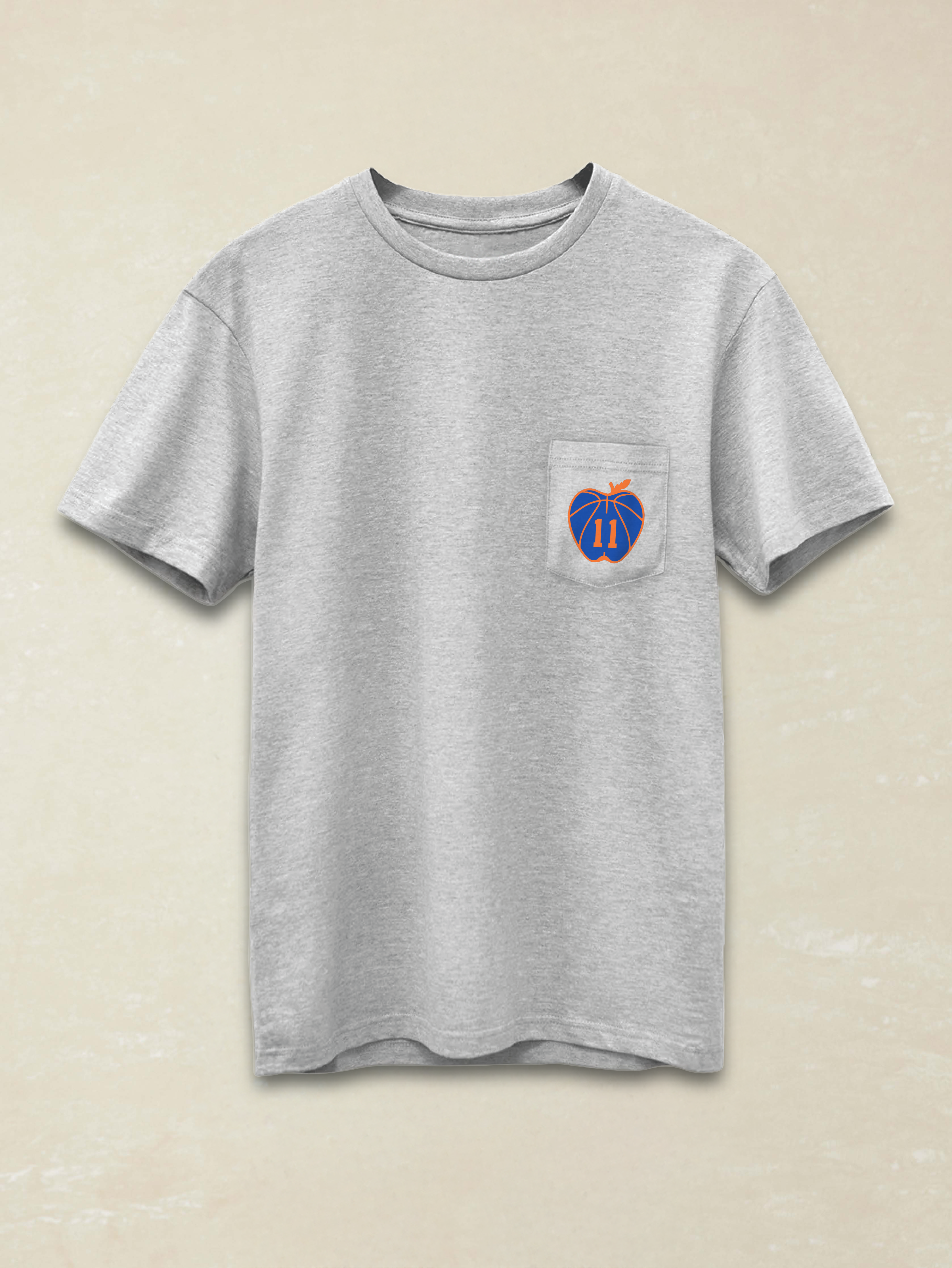 Gray t-shirt with a small logo on the chest against a beige background