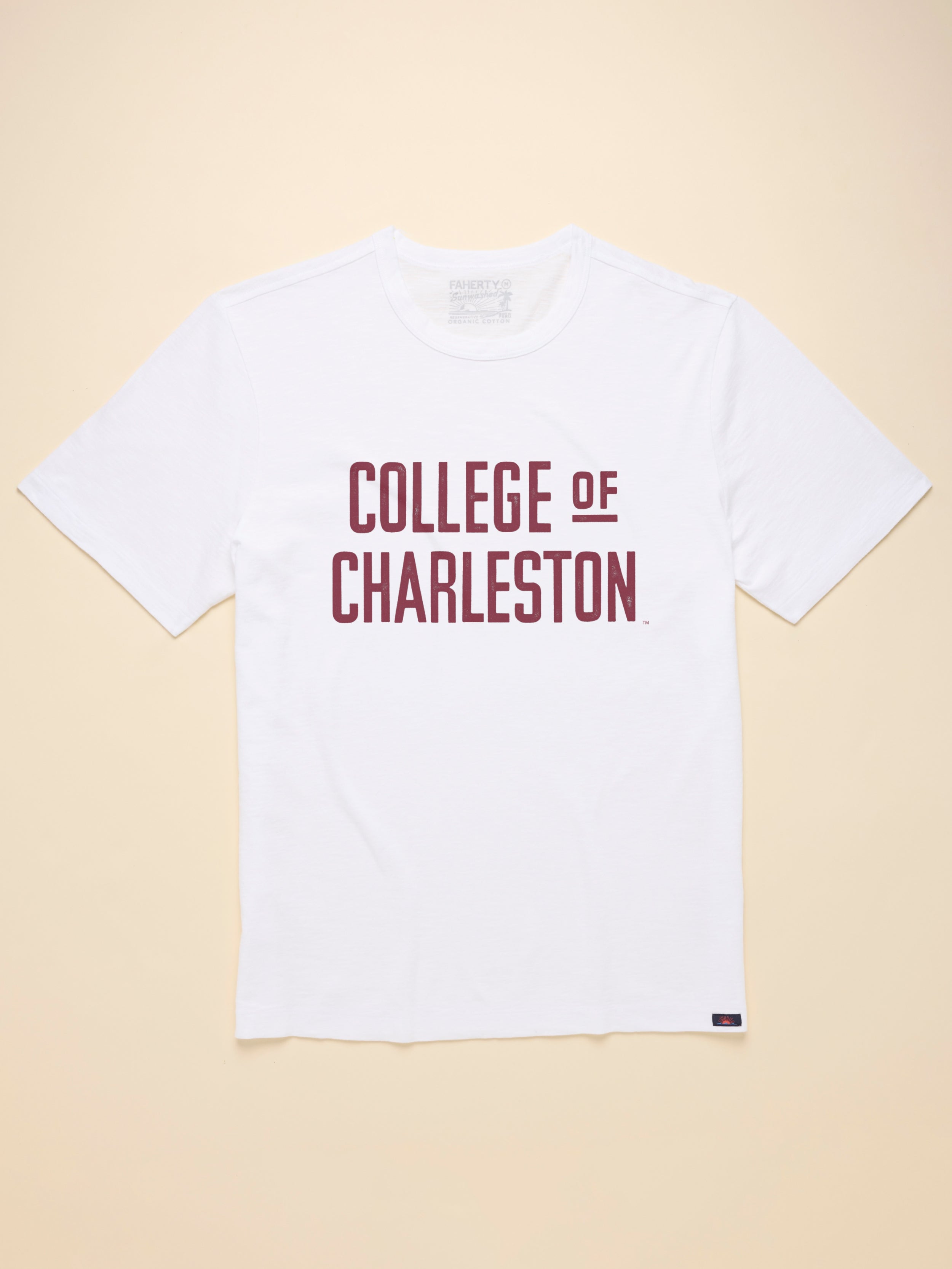 White t-shirt with College of Charleston graphic on the center front against a beige background