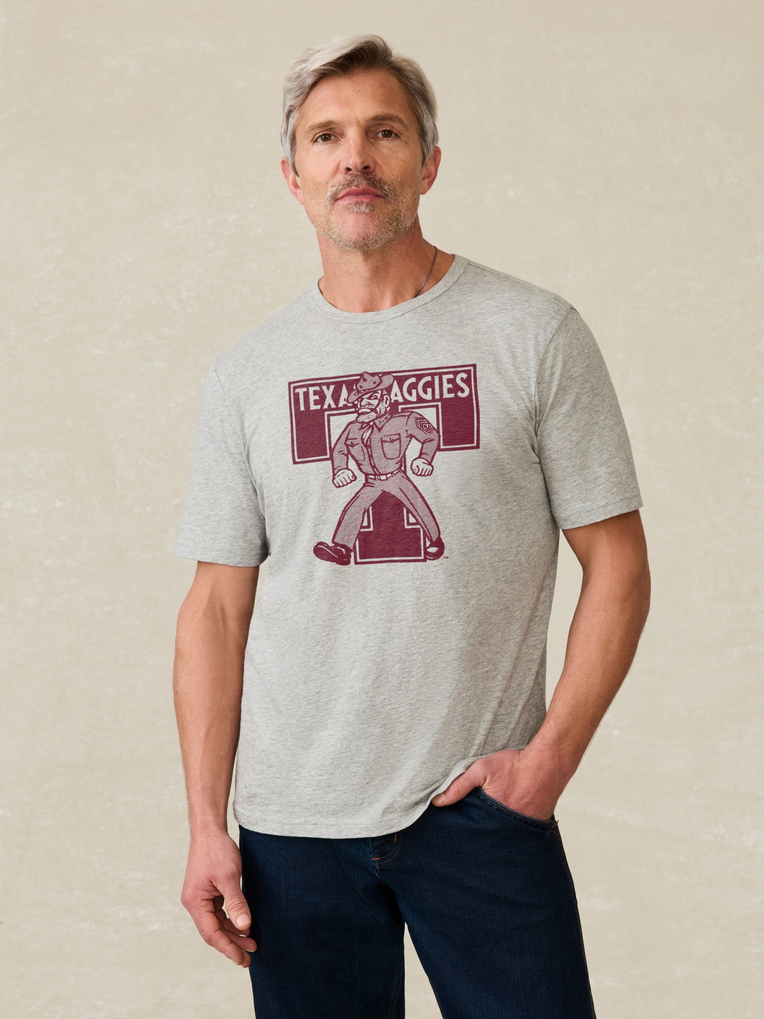 Grey t-shirt with Texas A&M graphic on front against a beige background