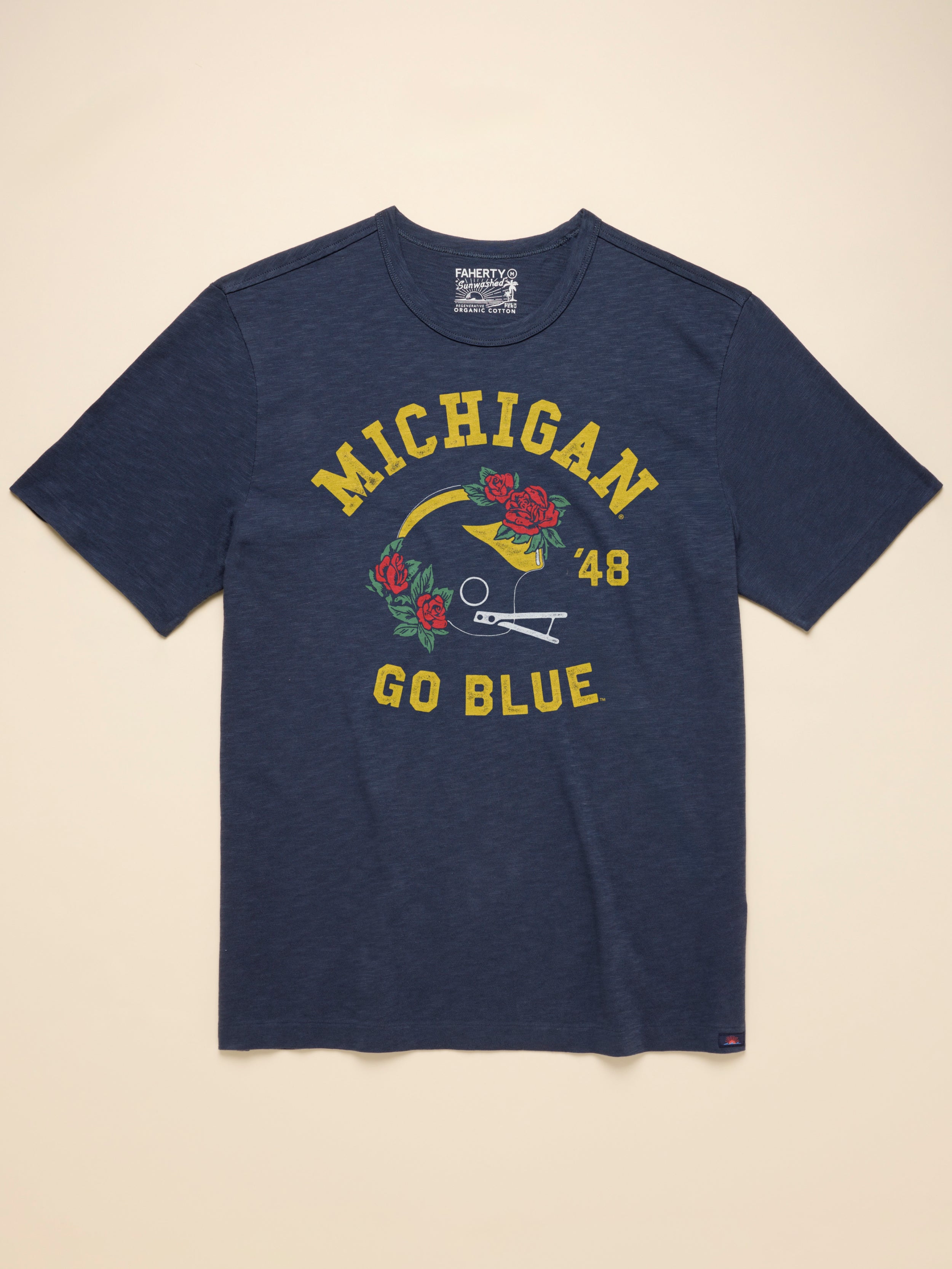 Navy t-shirt with Michigan graphic against a beige background