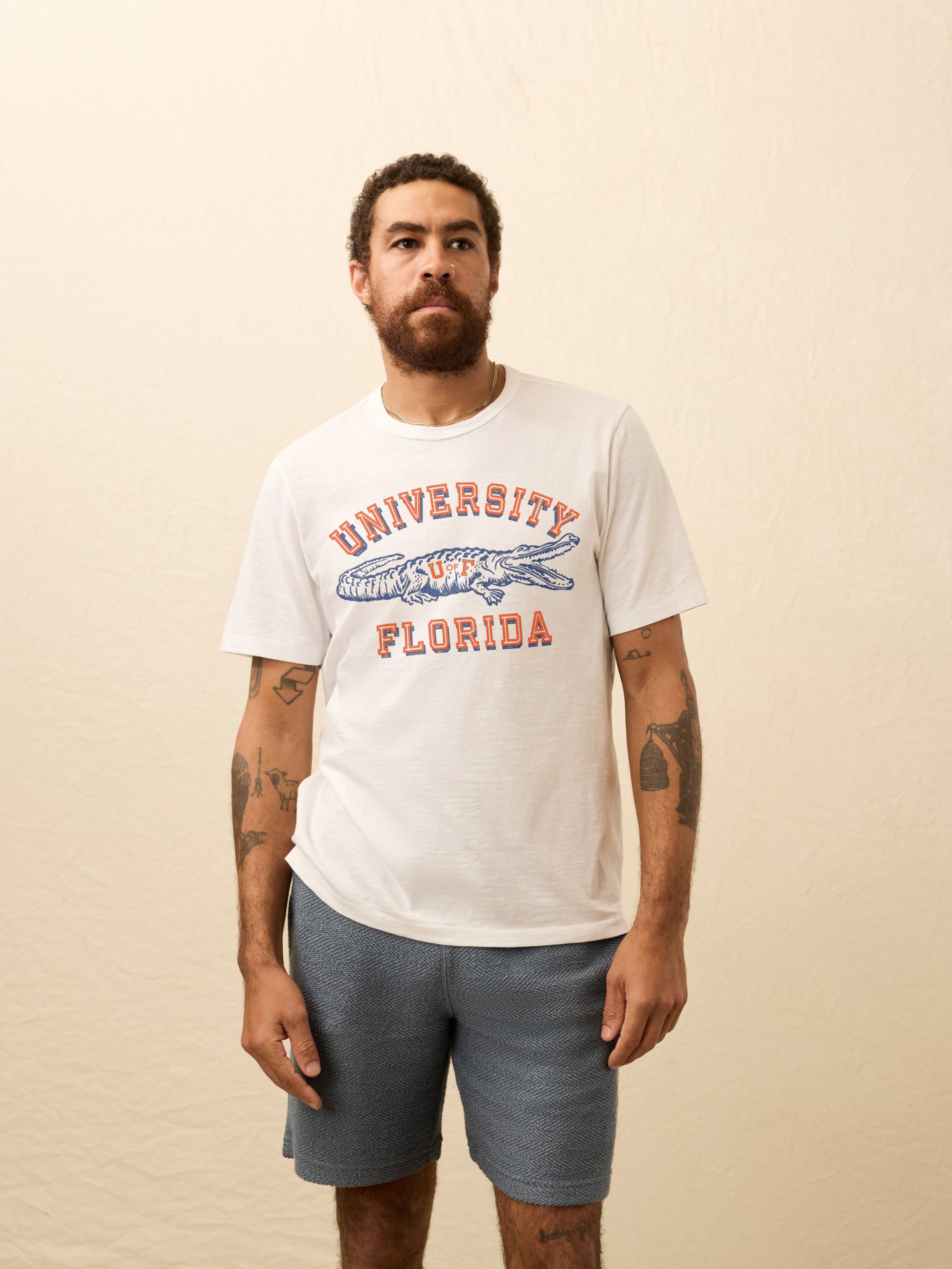 White t-shirt with University of Florida graphic on the front against beige background