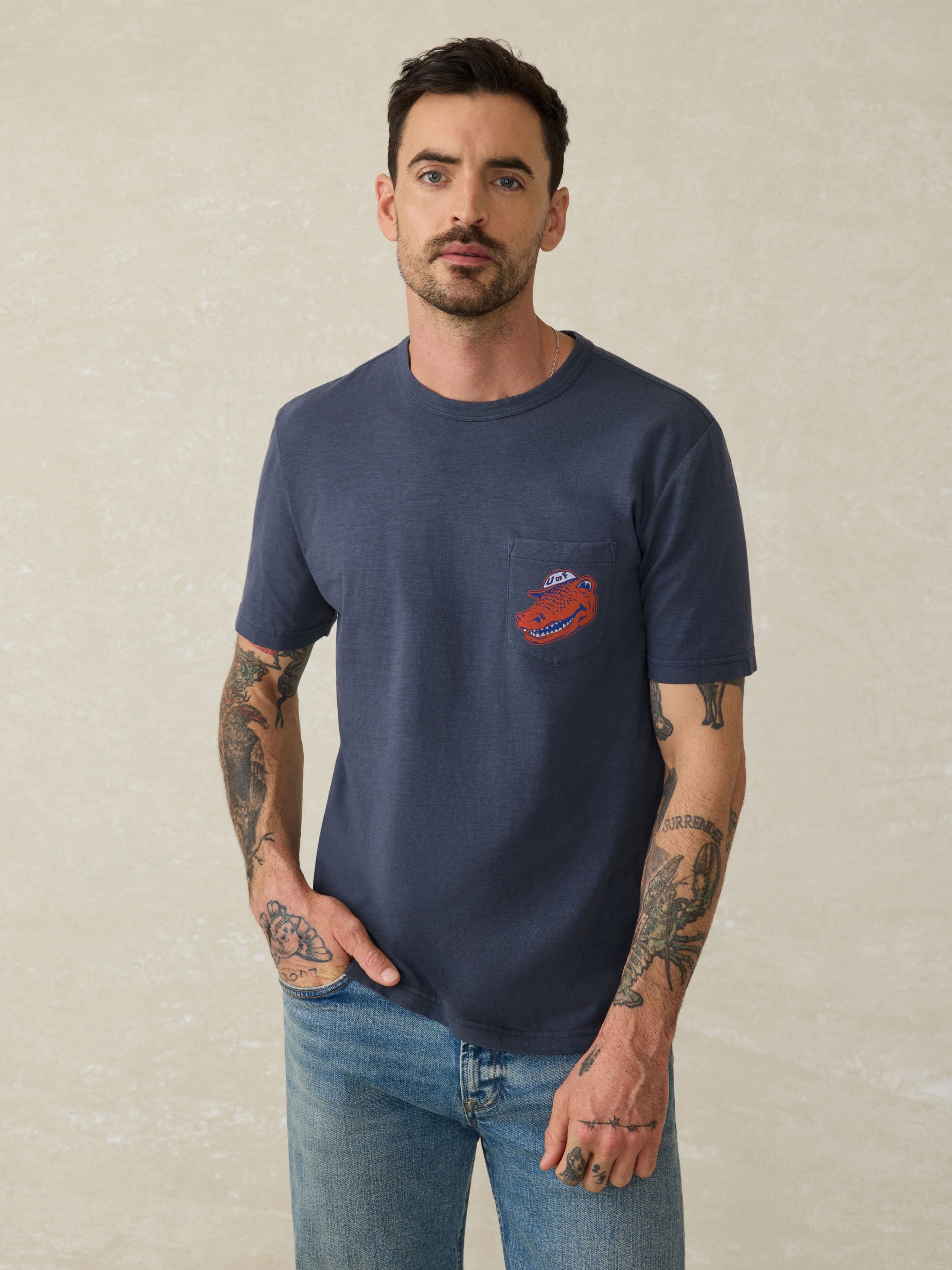Navy blue t-shirt with a Florida logo on the left chest against a beige background