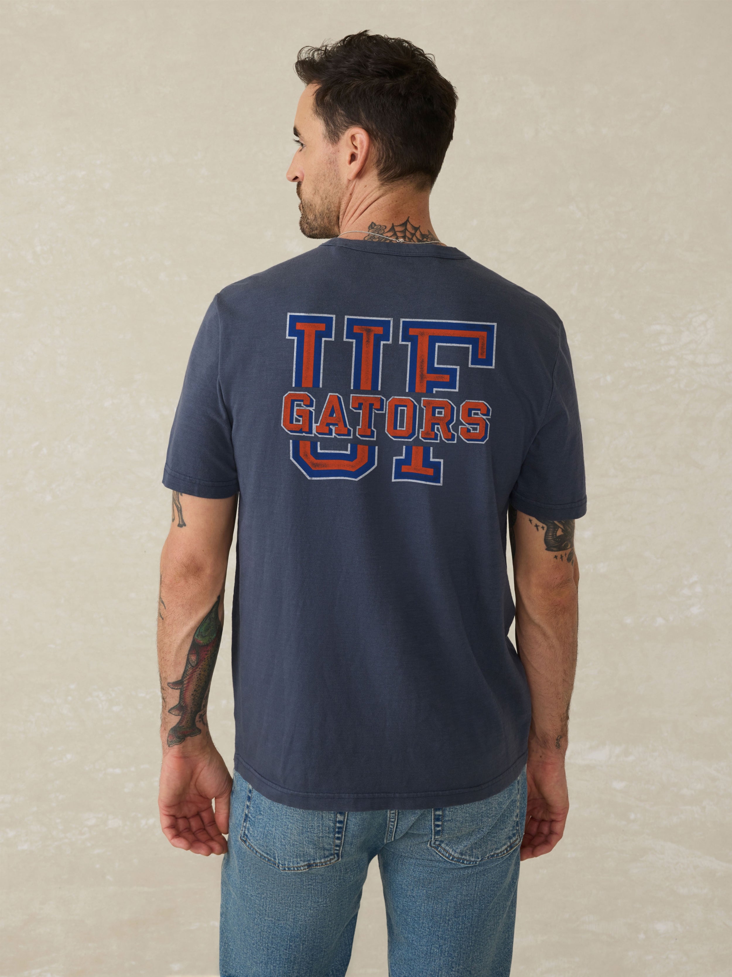 Navy blue t-shirt with a Florida logo on the back against a beige background