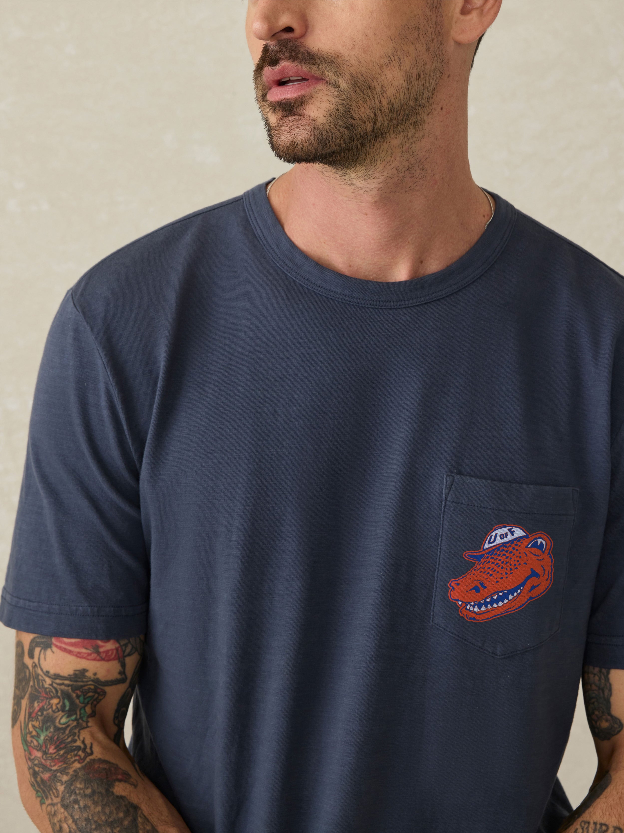 Navy blue t-shirt with a Florida logo on the left chest against a beige background
