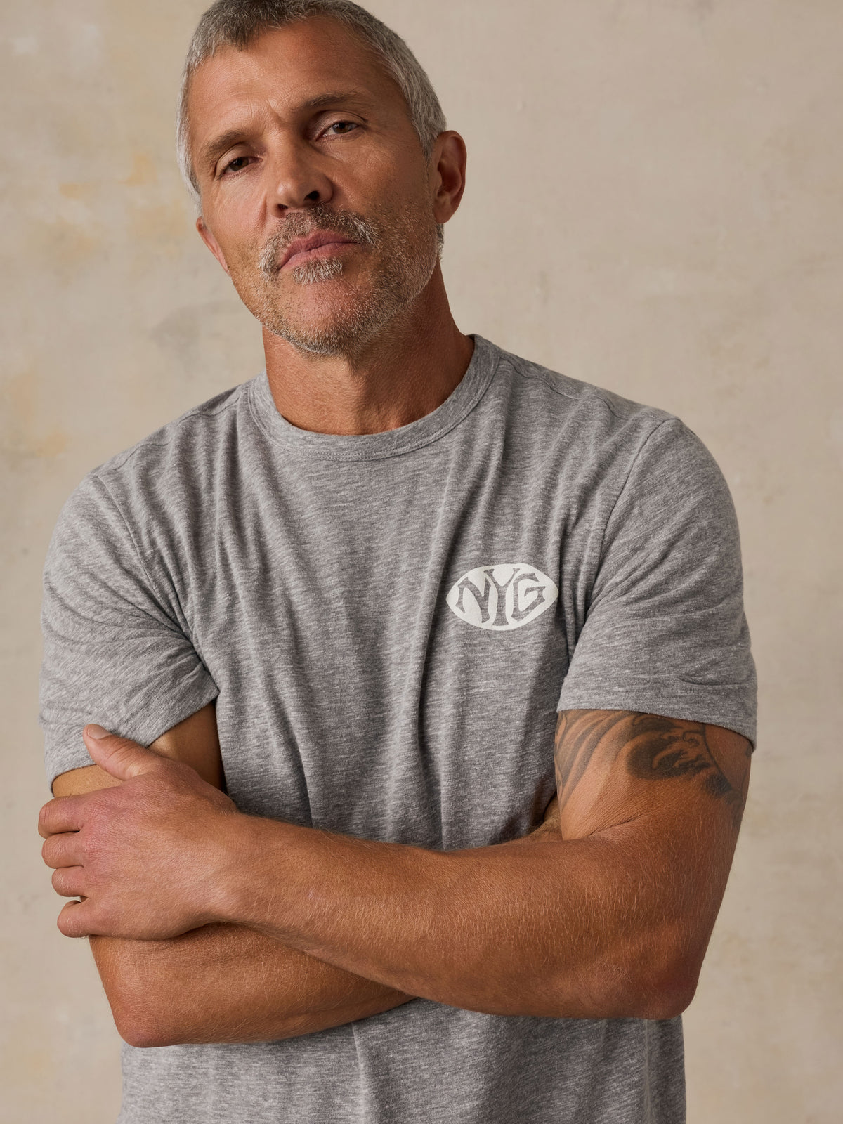 A man wearing a grey NY Giants t-shirt , image 3 of 6