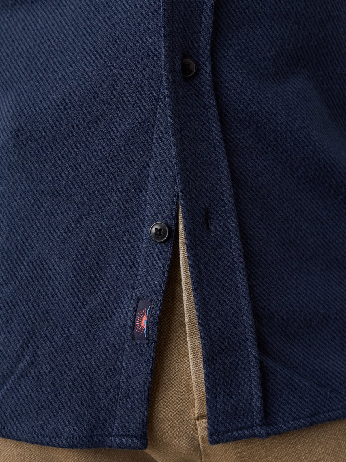 Close up of a man wearing a NY Giants shirt with a Faherty brand label near the hem, image 5 of 7