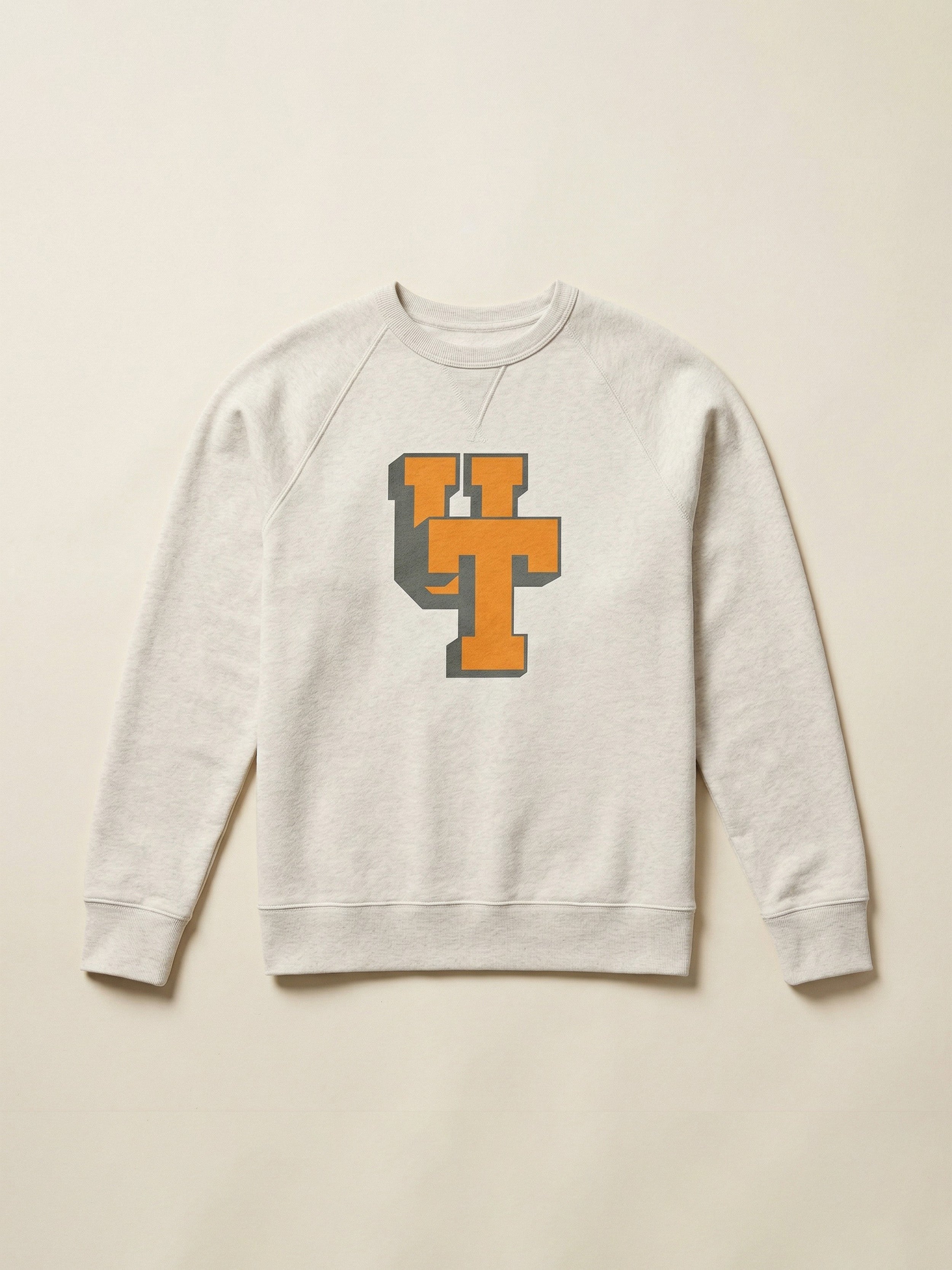 Ivory heather crewneck with University of Tennessee graphic logo on the center chest against a beige background