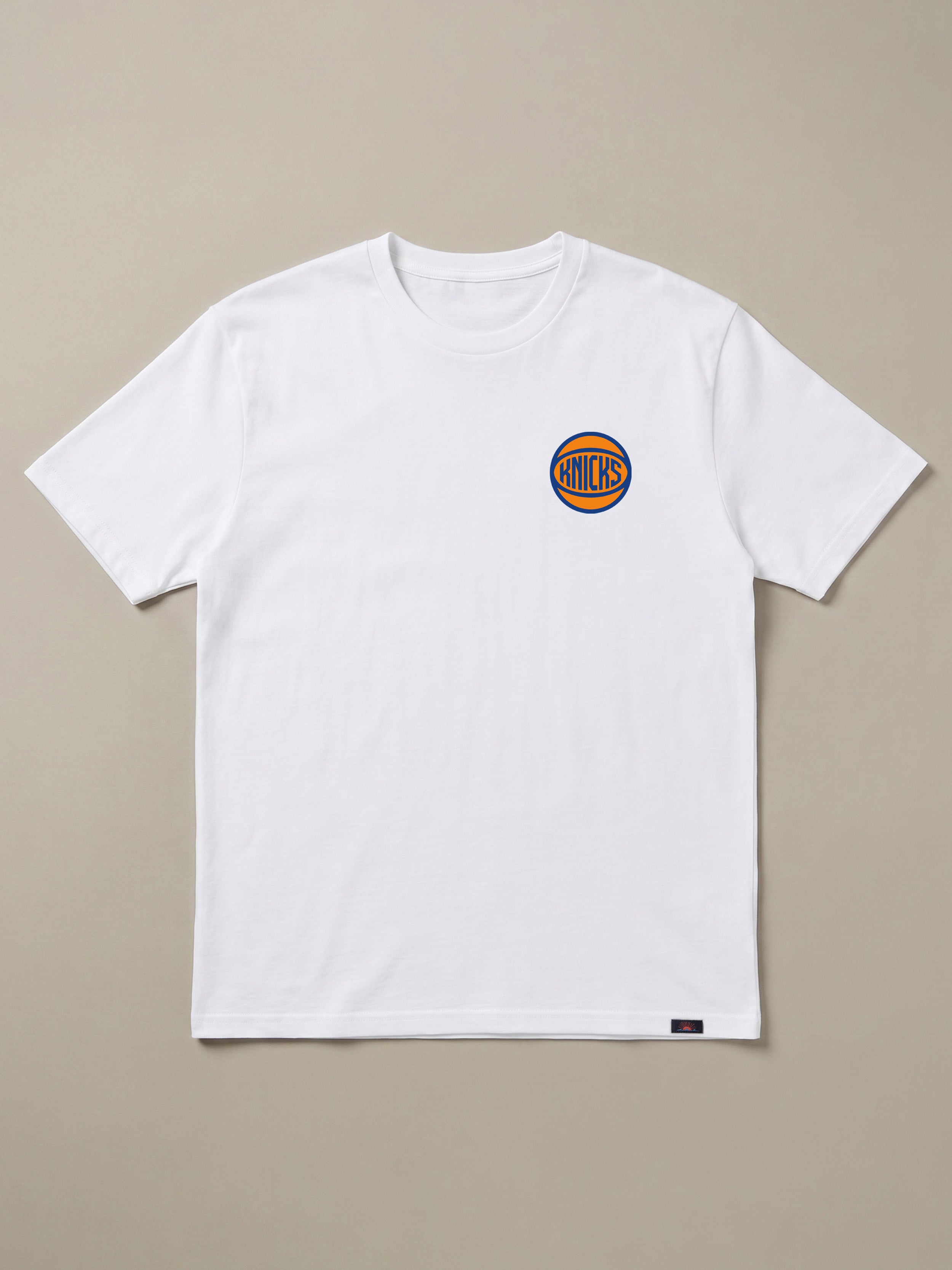 White t-shirt with a small NY Knicks logo on the left chest against a beige background