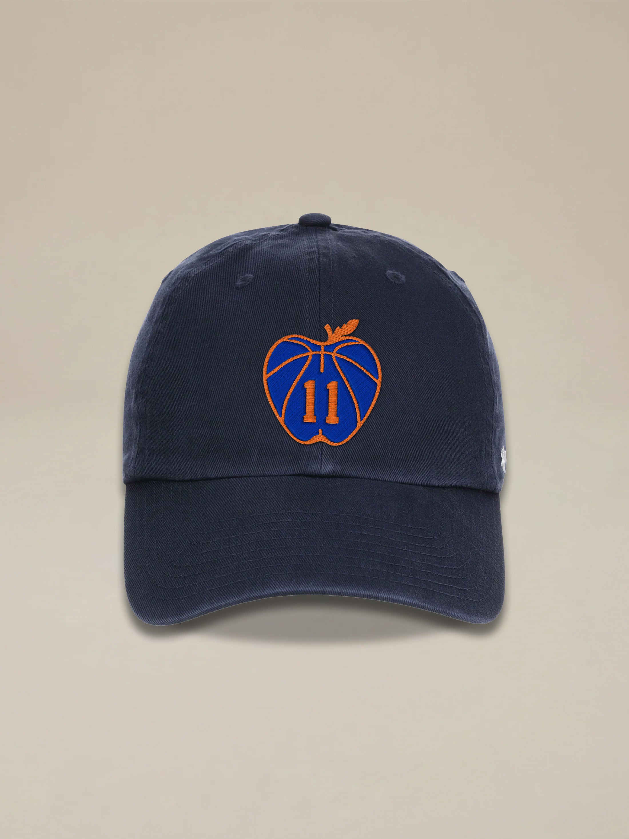 Blue hat with Jalen Brunson graphic on the center front against a beige background