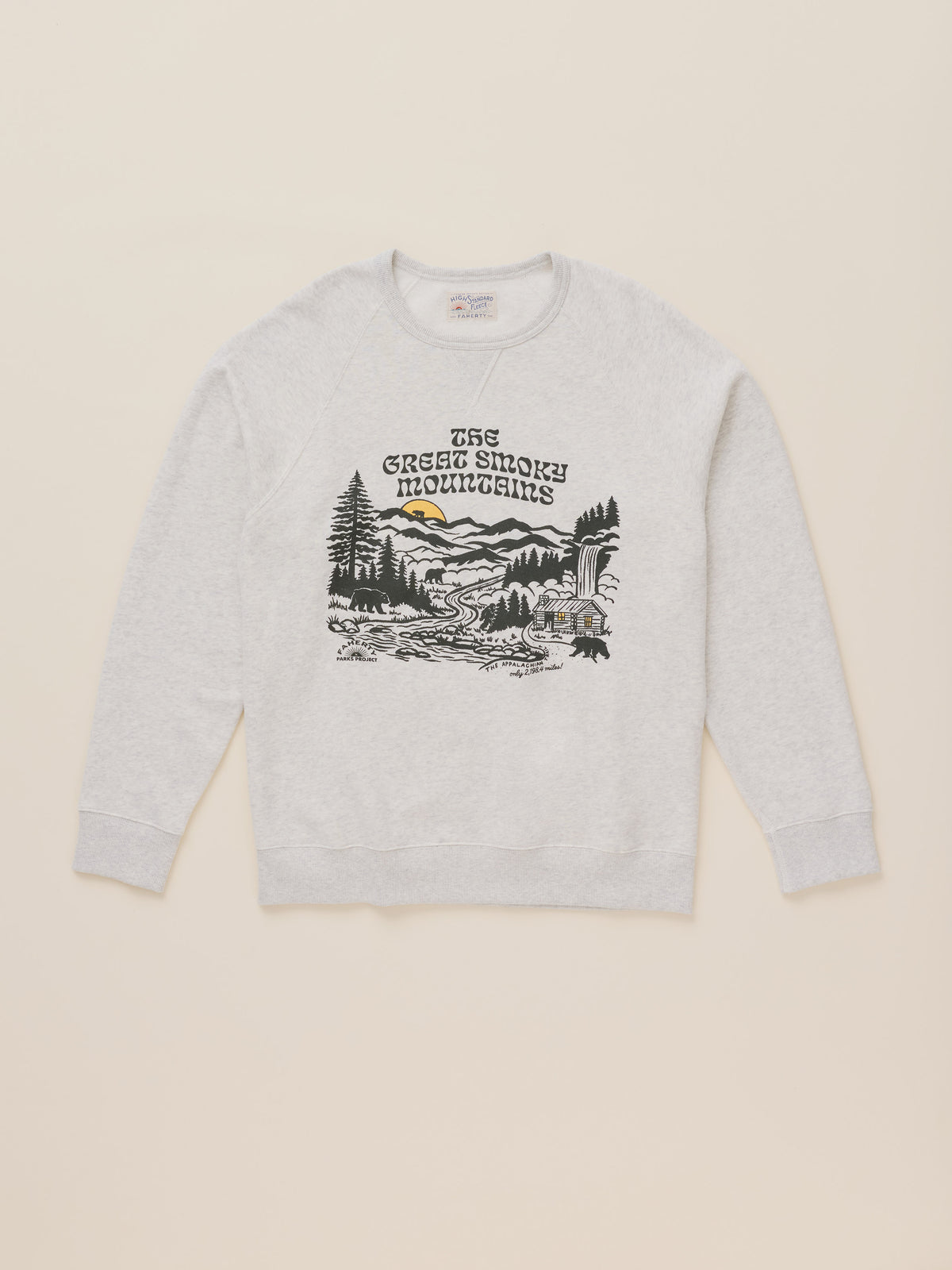 A light heather gray crewneck sweatshirt featuring a black and white graphic of 'The Green Smoke Mountains' with a small yellow sun detail, displayed flat against a light beige background., image 7 of 7