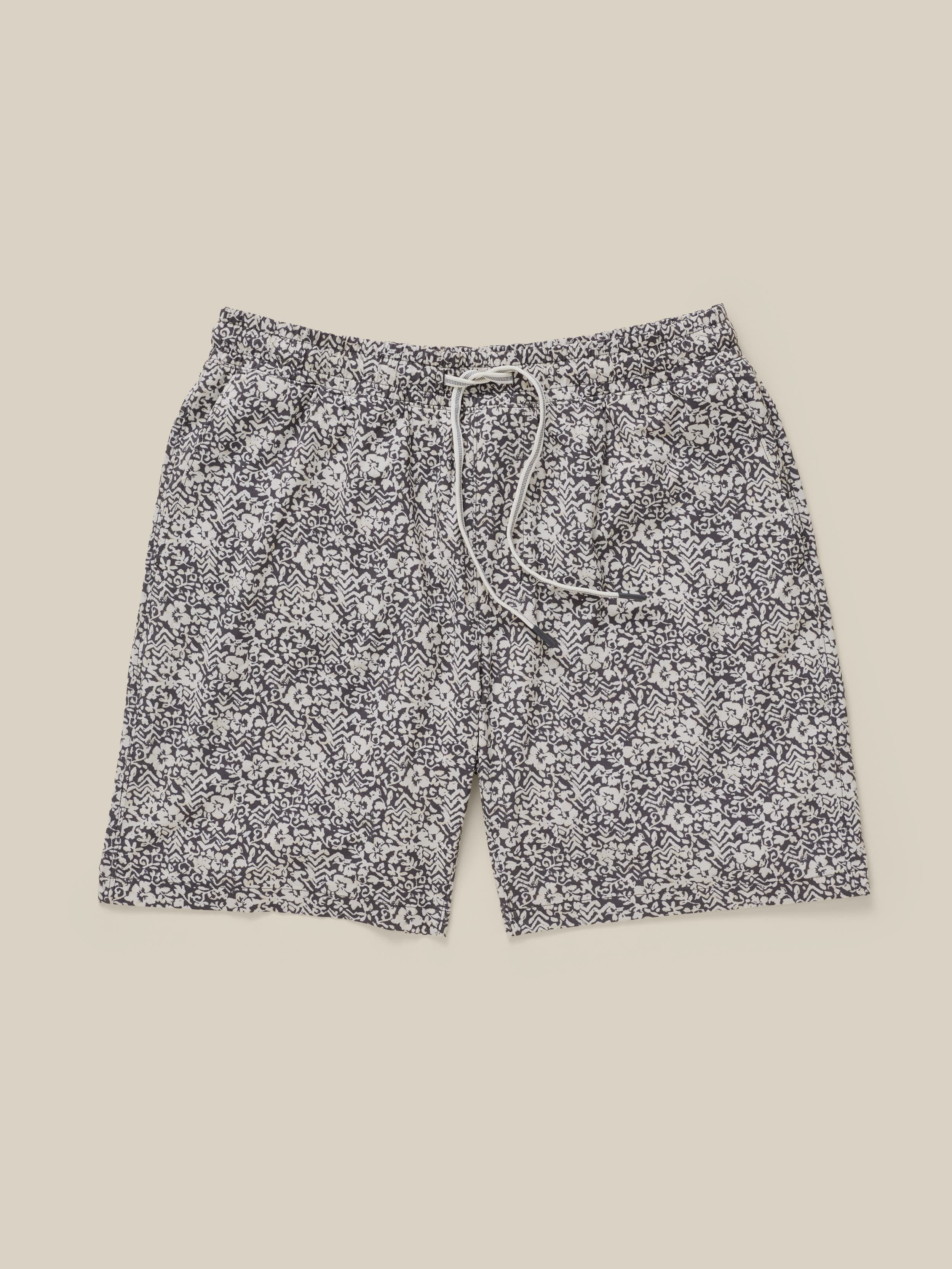 Floral patterned shorts on a beige background
