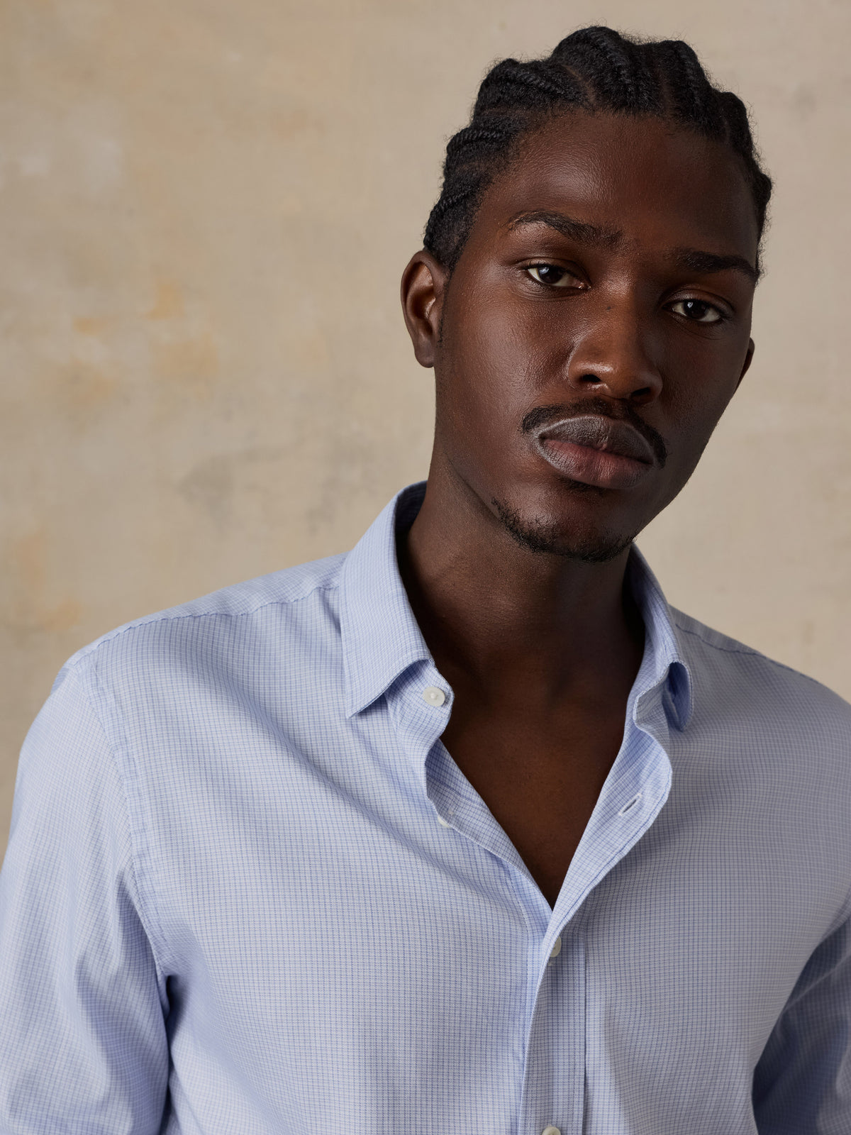 Close up of a man wearing a blue shirt, image 3 of 5