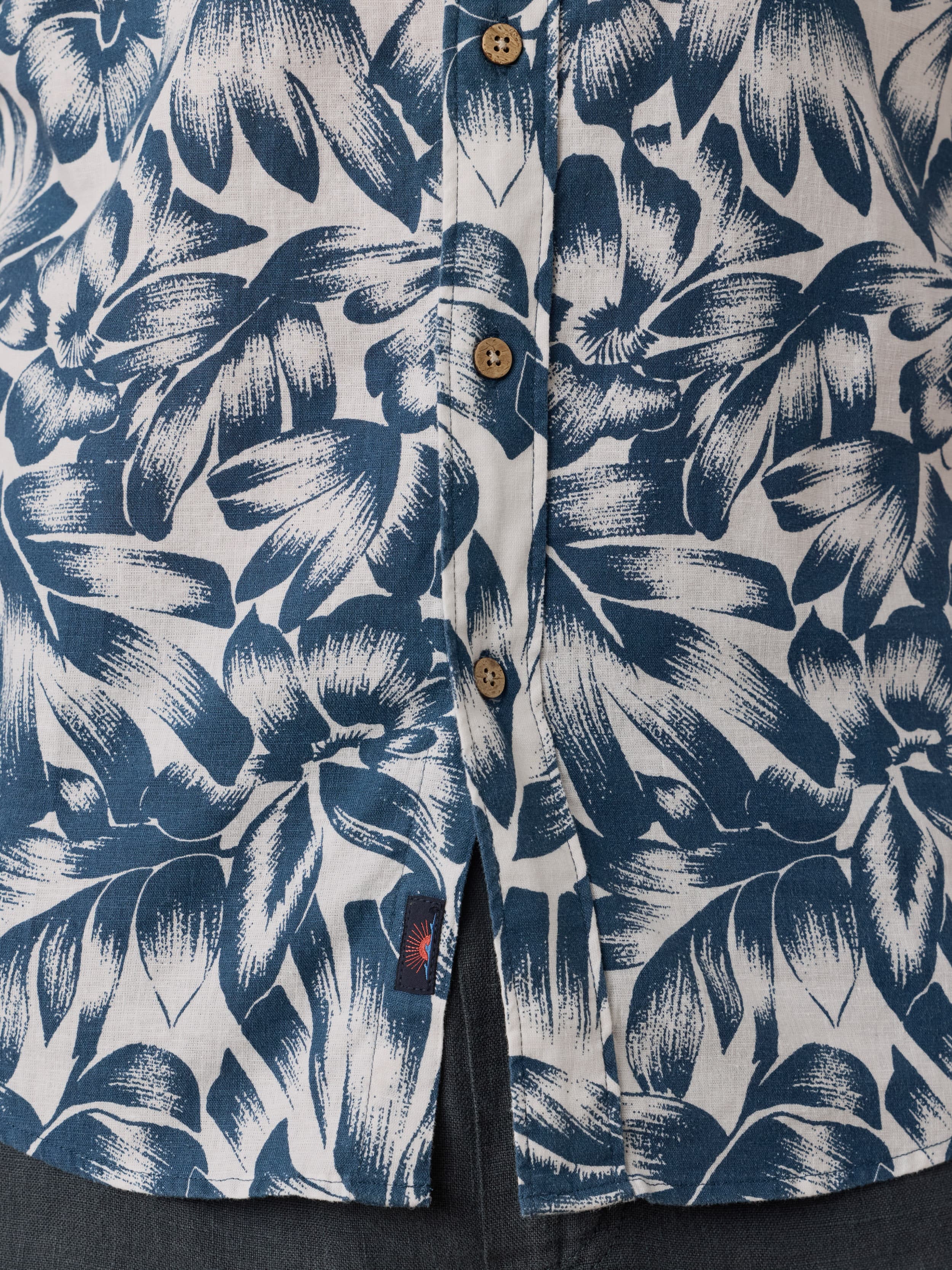 Floral patterned shirt with blue and white design and Faherty brand logo near the hem