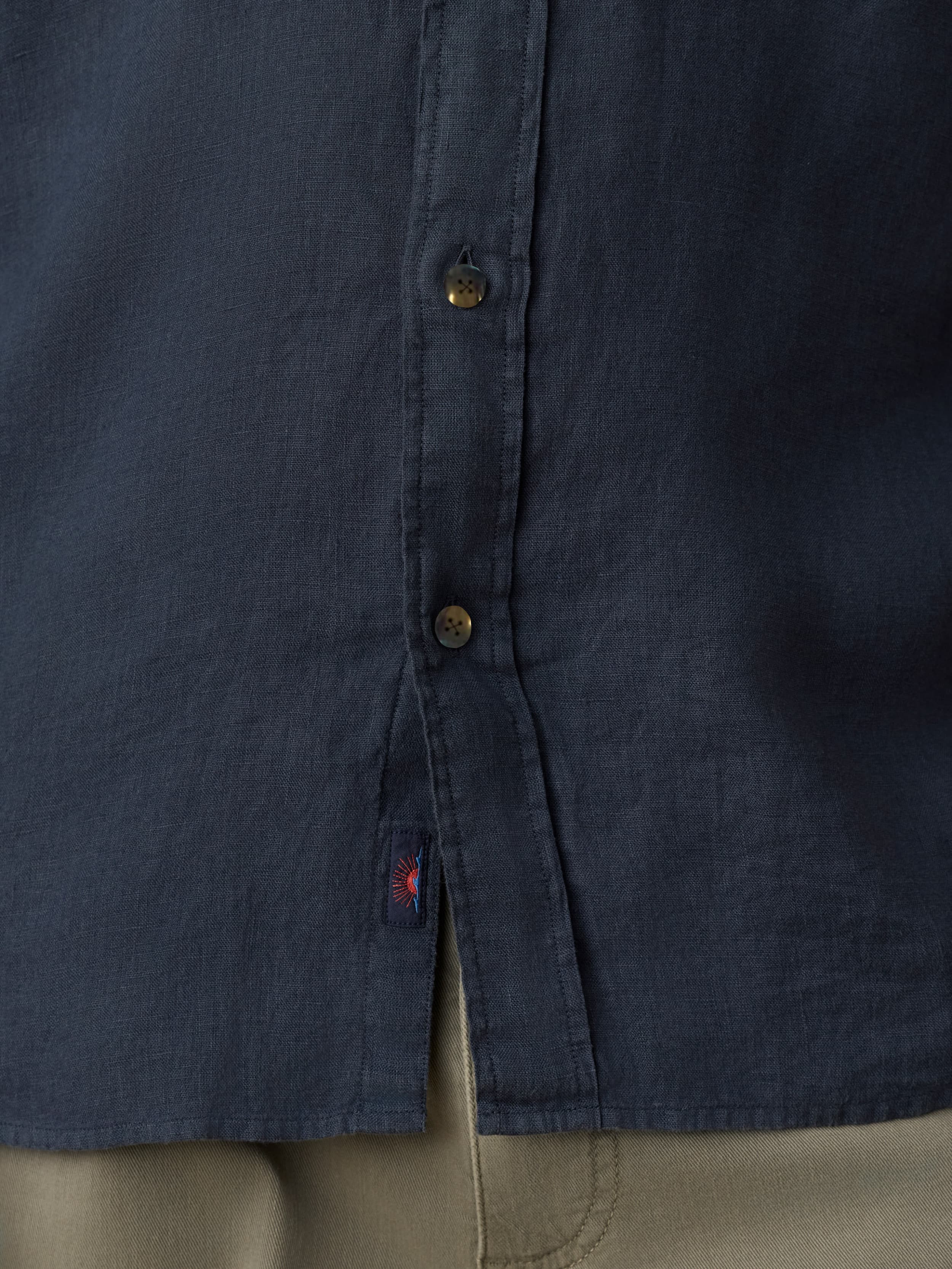 Navy blue shirt with button details and a visible Faherty brand label