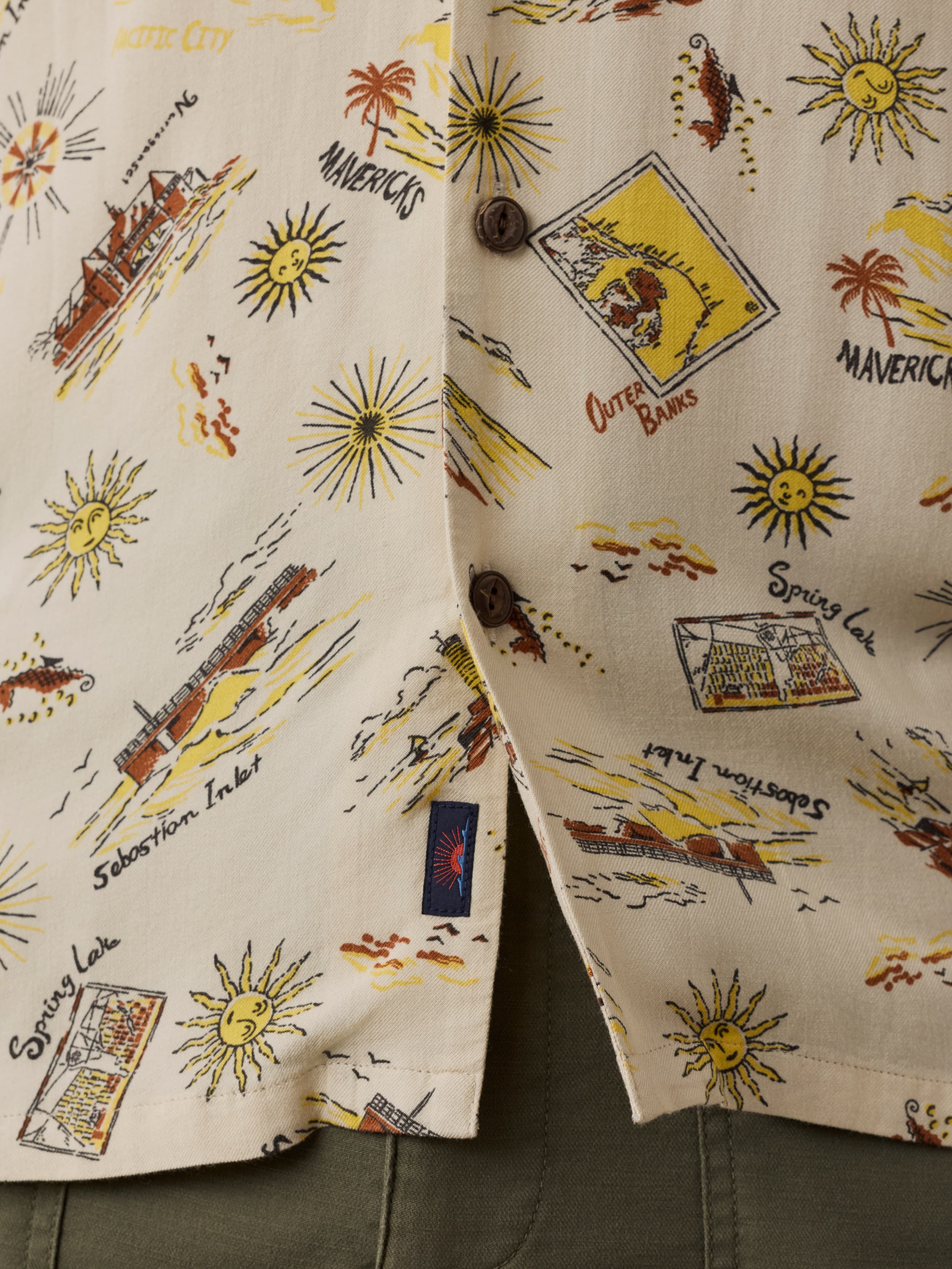 Close-up of a shirt with vintage-style graphics and text on a beige background