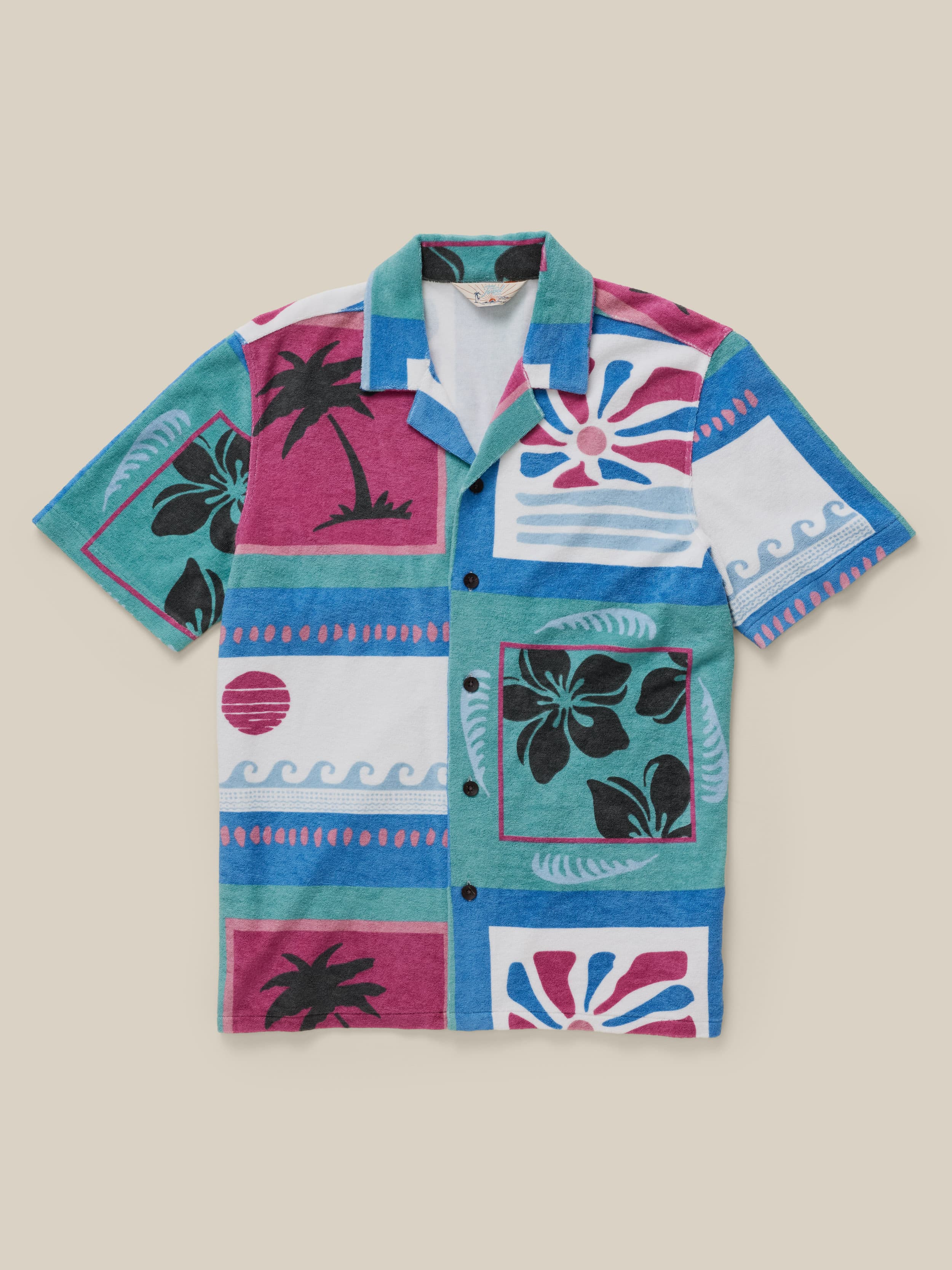Colorful patterned shirt with tropical designs on a beige background