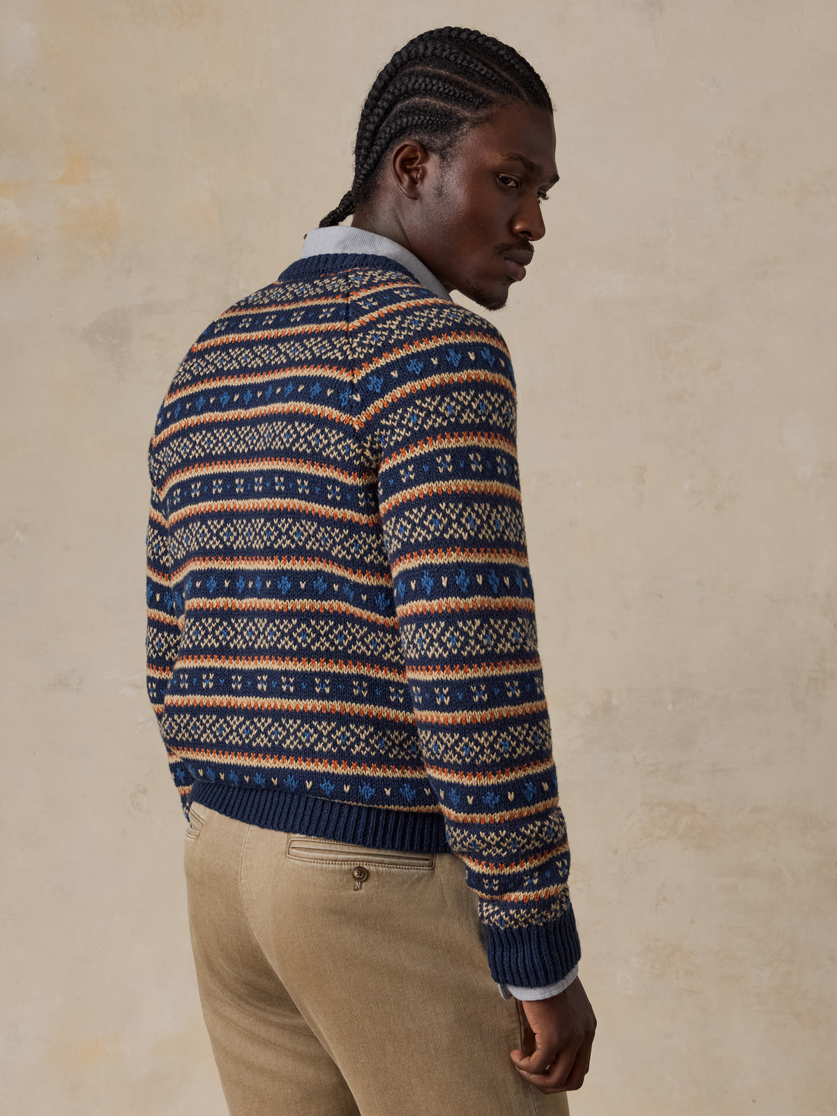 Man viewed from the back wearing a nordic printed sweater and beige pants , image 3 of 6
