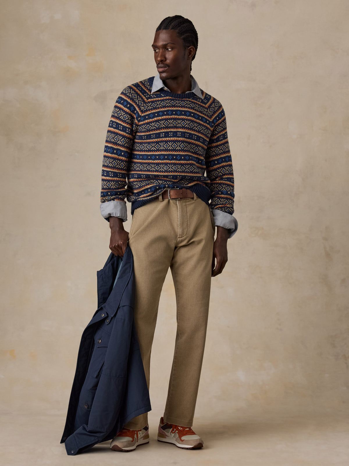 Man wearing a nordic printed sweater, beige pants, and sneakers , image 6 of 6