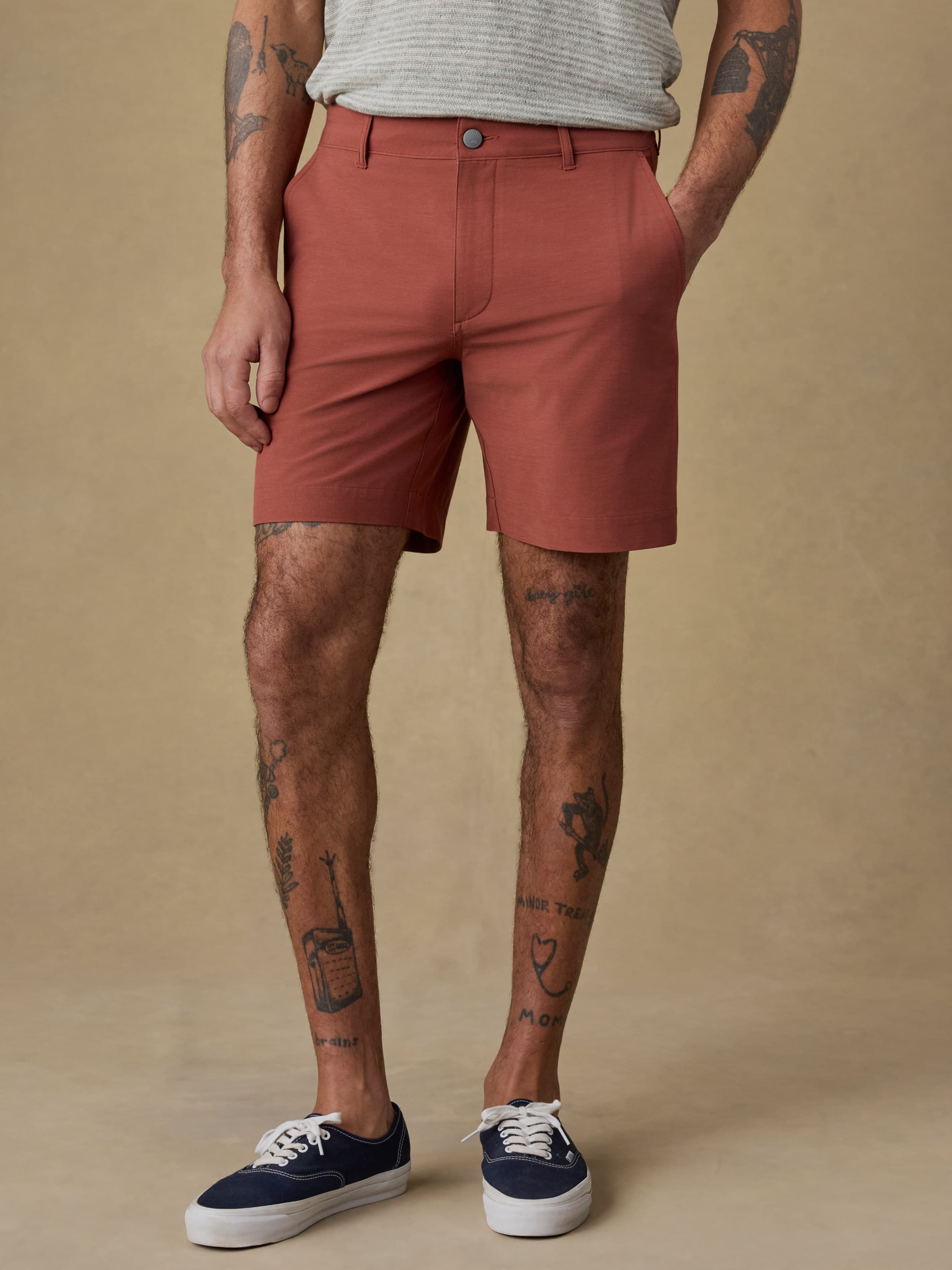 Man wearing red shorts on a beige background