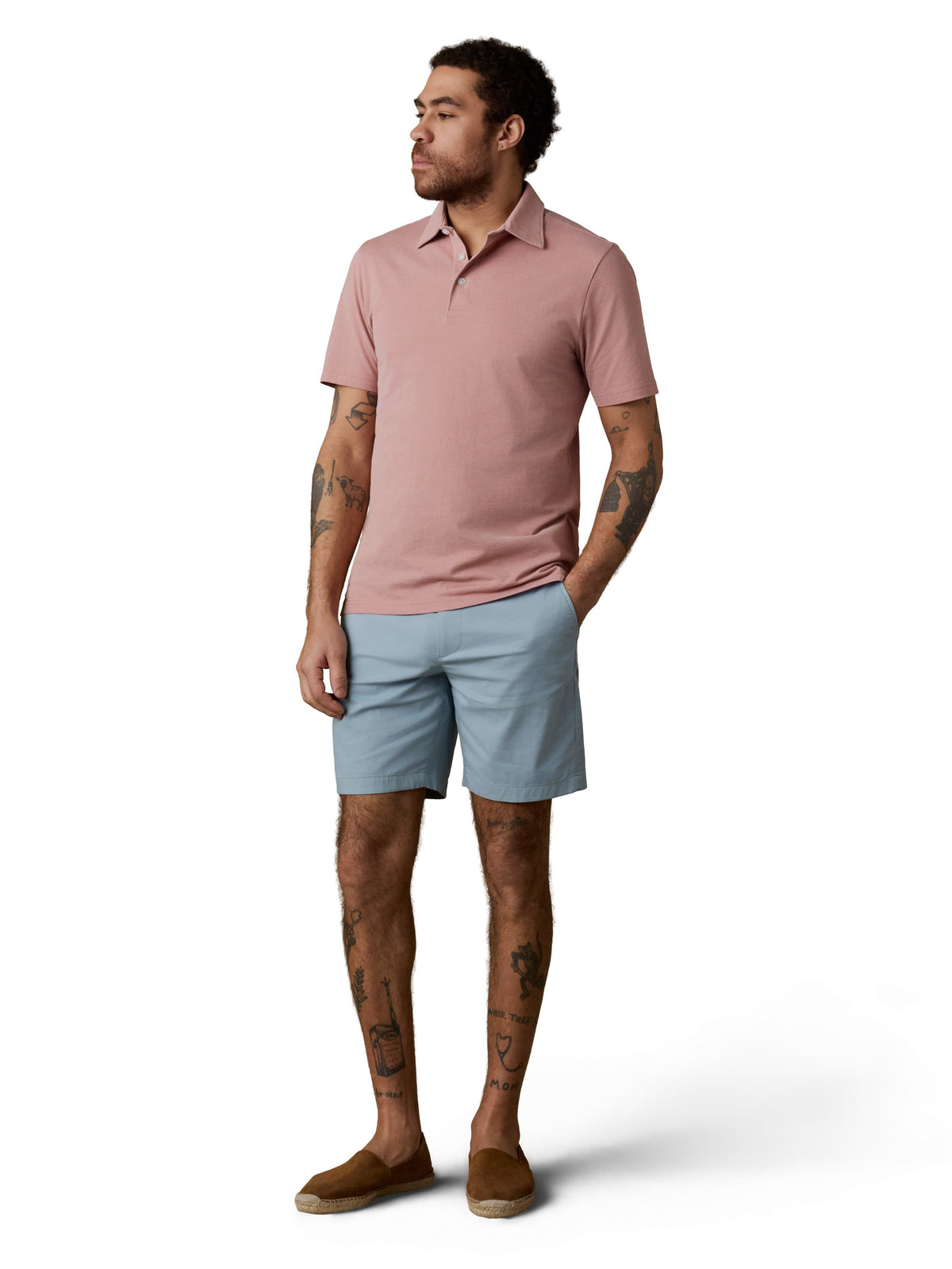 A man wearing a pink polo and light blue shorts, image 1 of 3