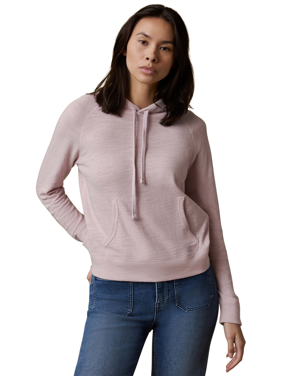 A woman wearing a light purple hoodie and blue jeans, image 1 of 3