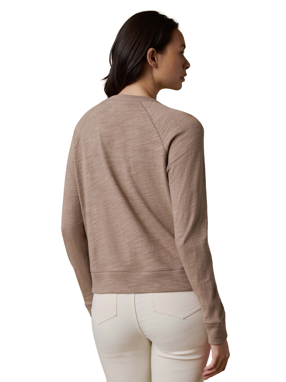 A woman viewed from behind wearing a beige crewneck and white pants, image 3 of 3