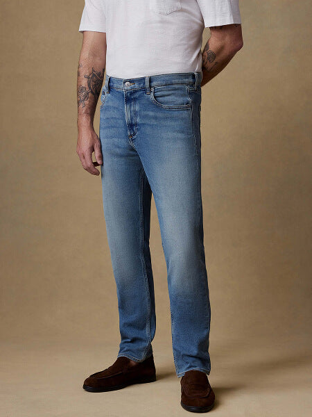 Lower half of model wearing stretch terry pants in indigo wash