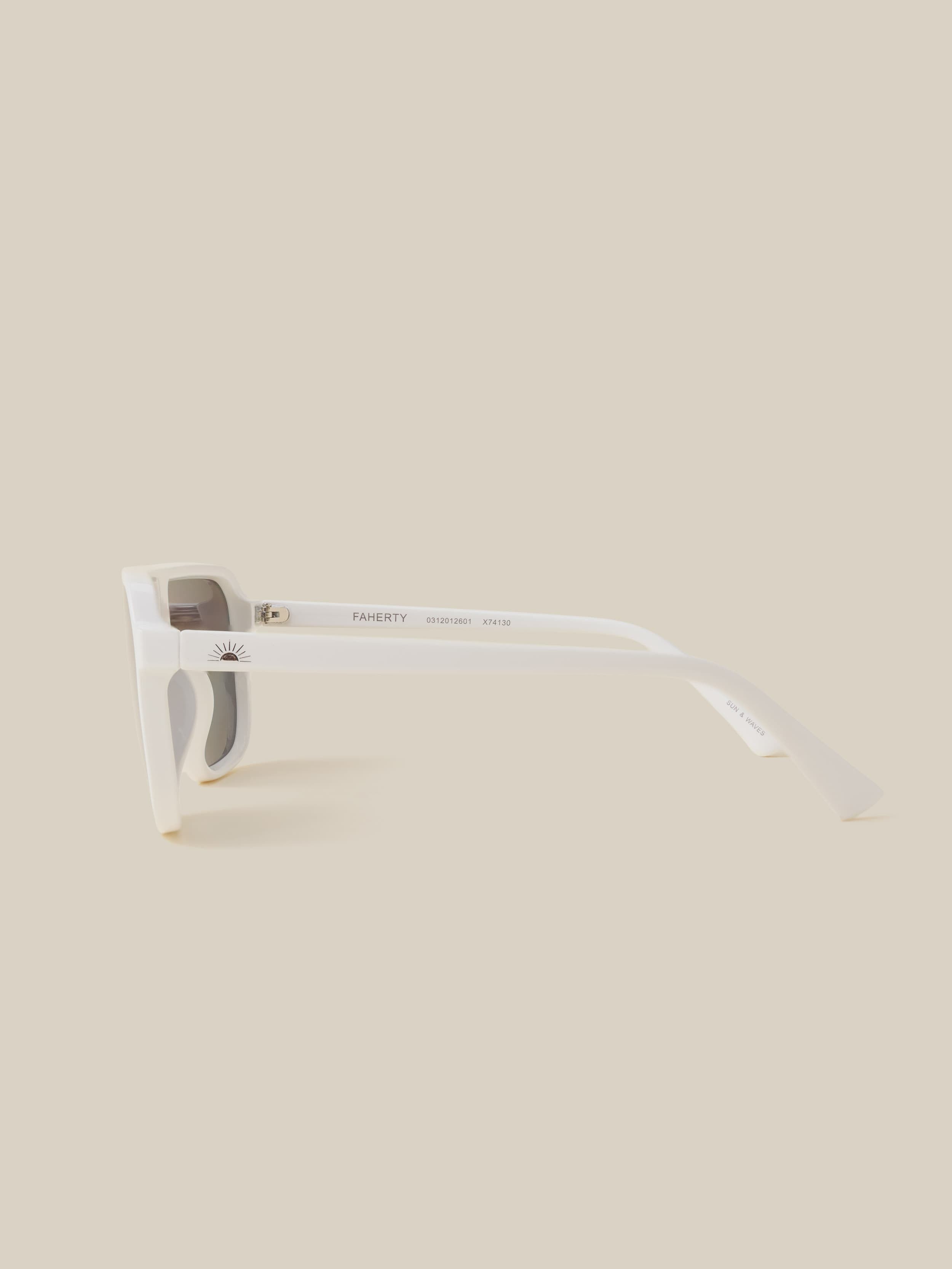 White sunglasses with a beige background