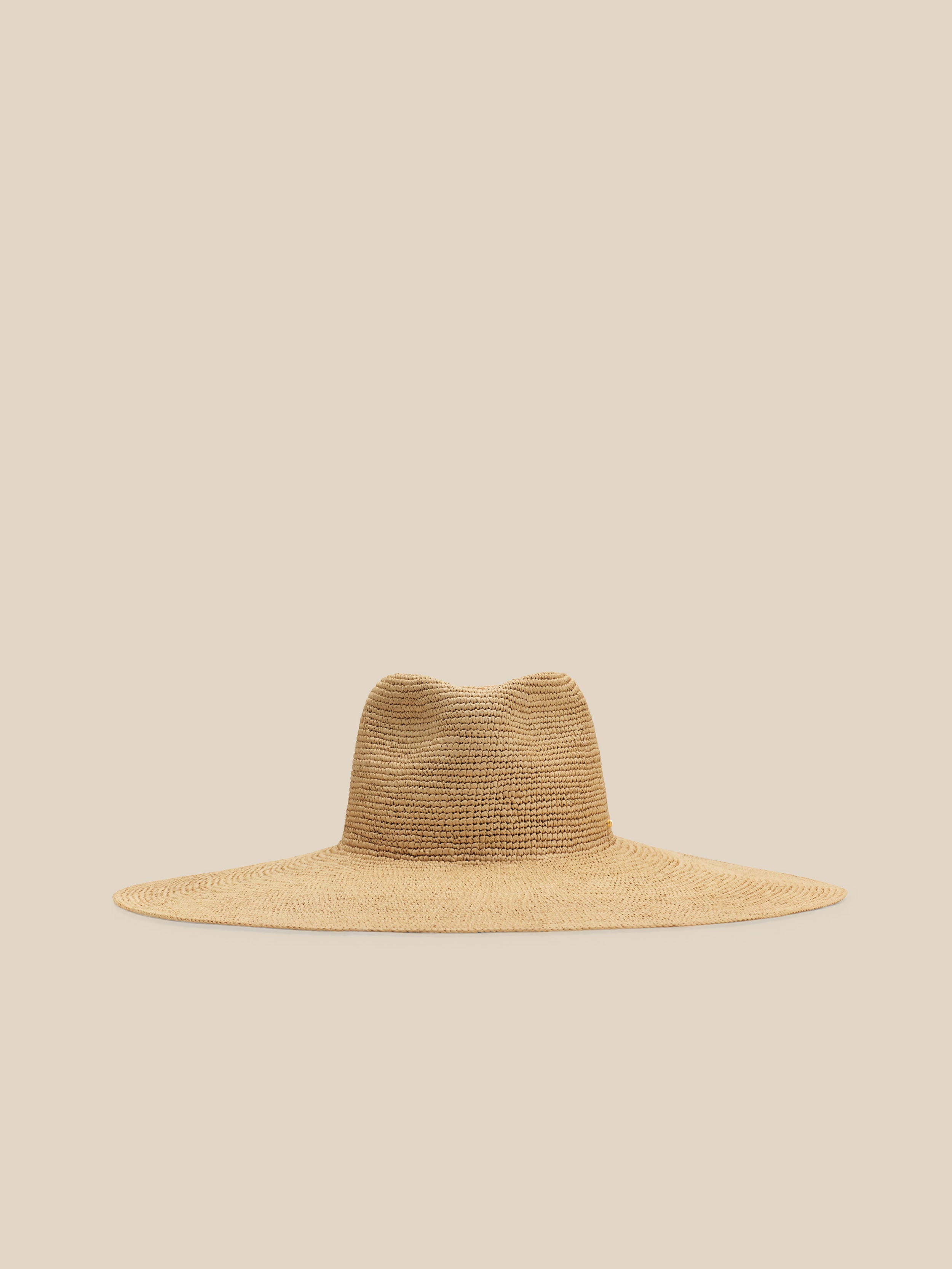 Beige straw hat on a beige background