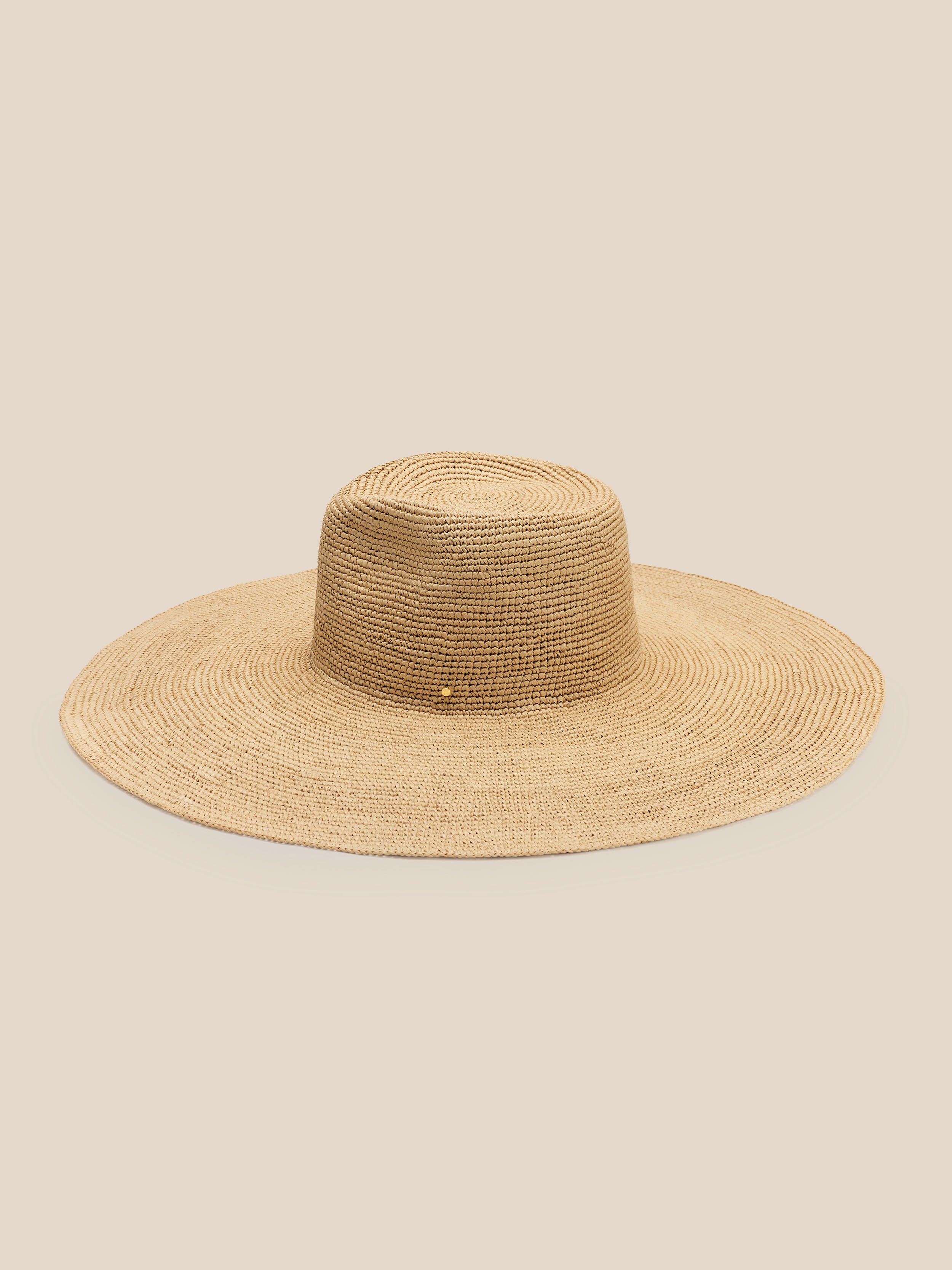 Beige straw hat on a beige background