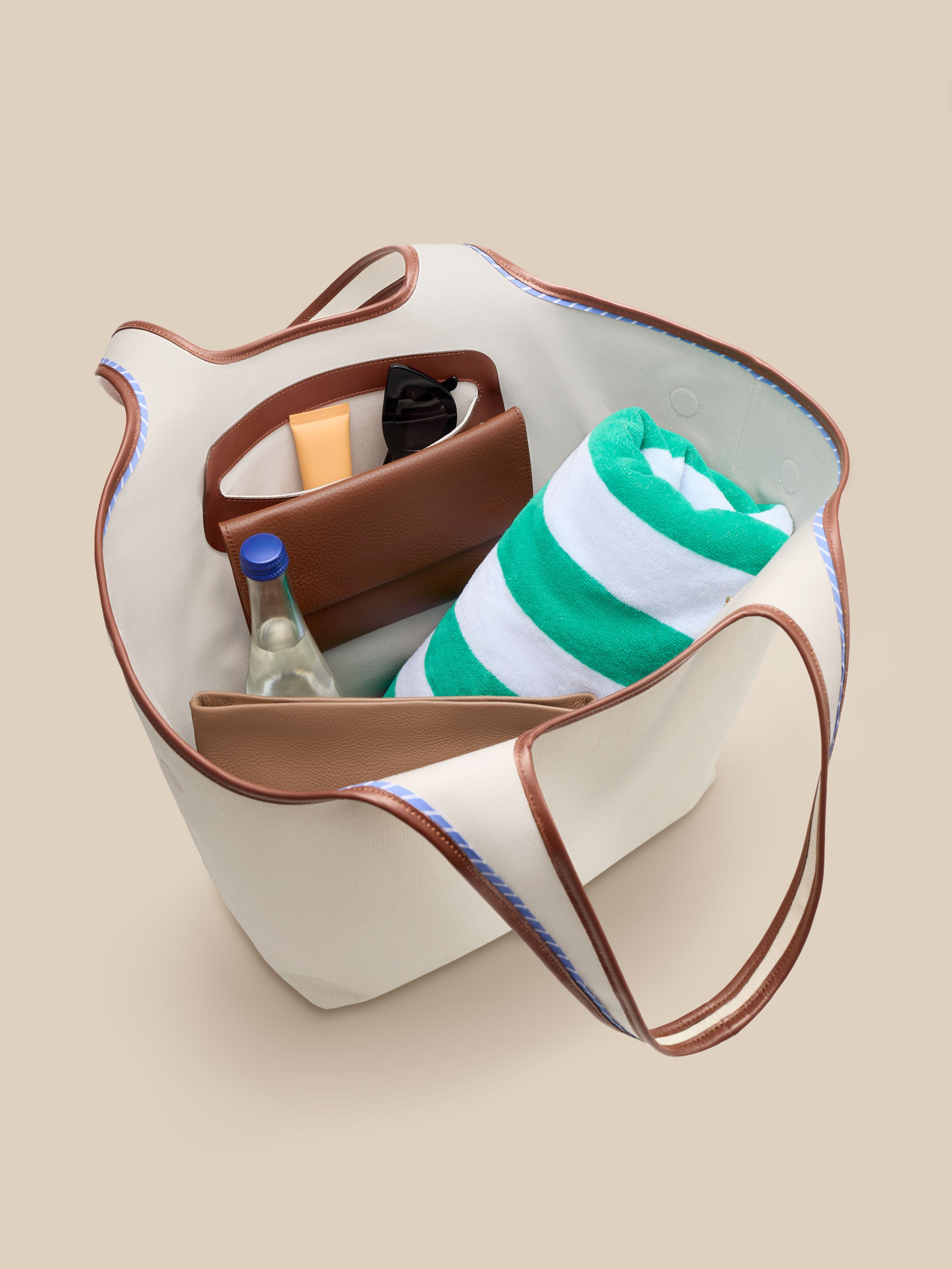 Beige canvas handbag with a beige interior on a beige background