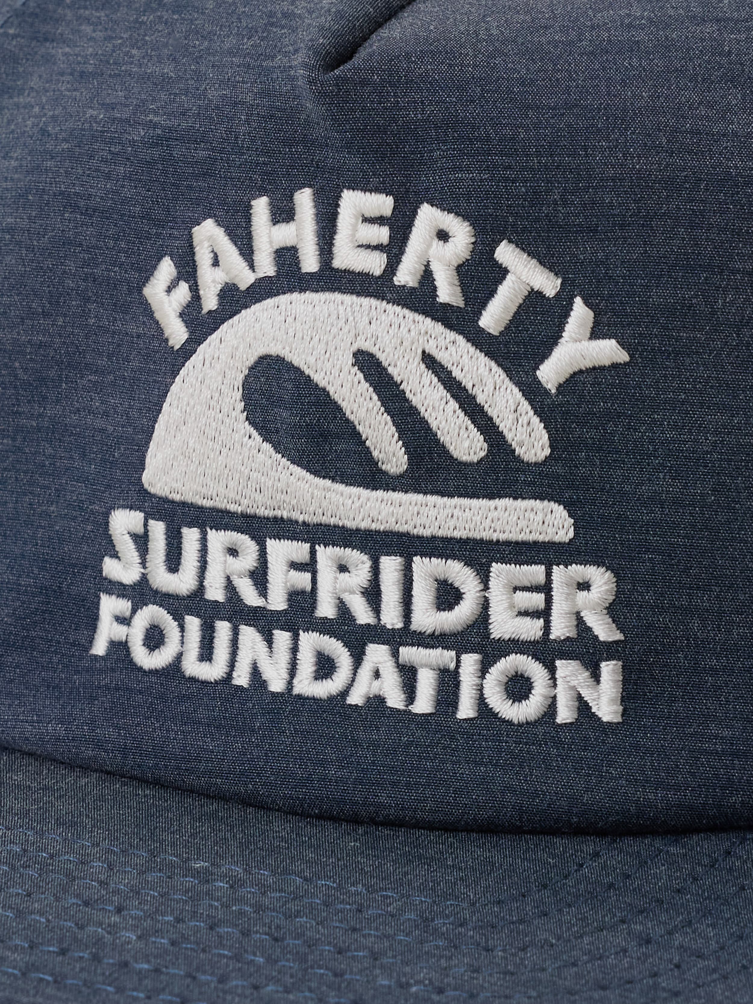 Blue cap with 'Faherty x Surfrider Foundation' logo on a beige background